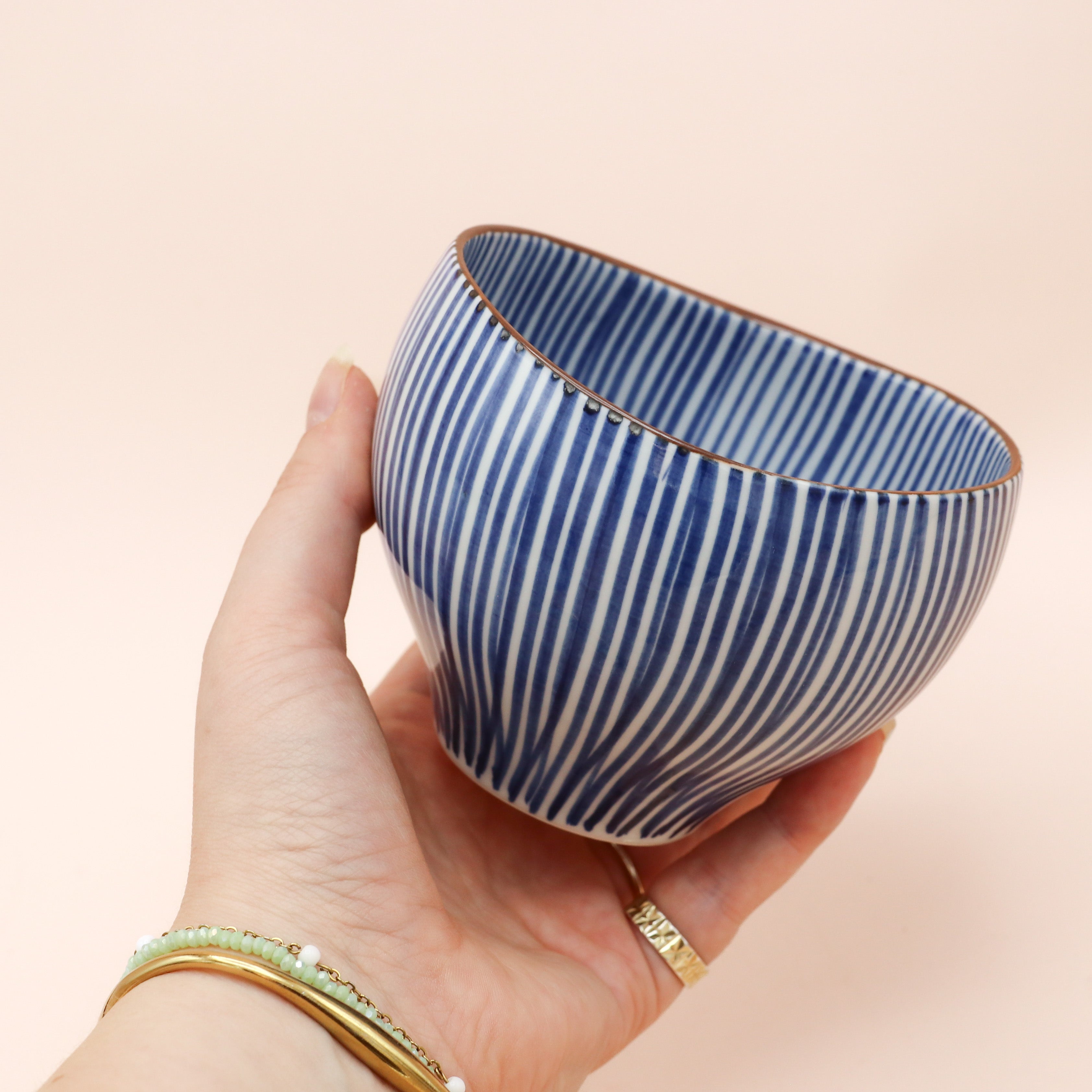 Cup with blue vertical stripes and brown rim