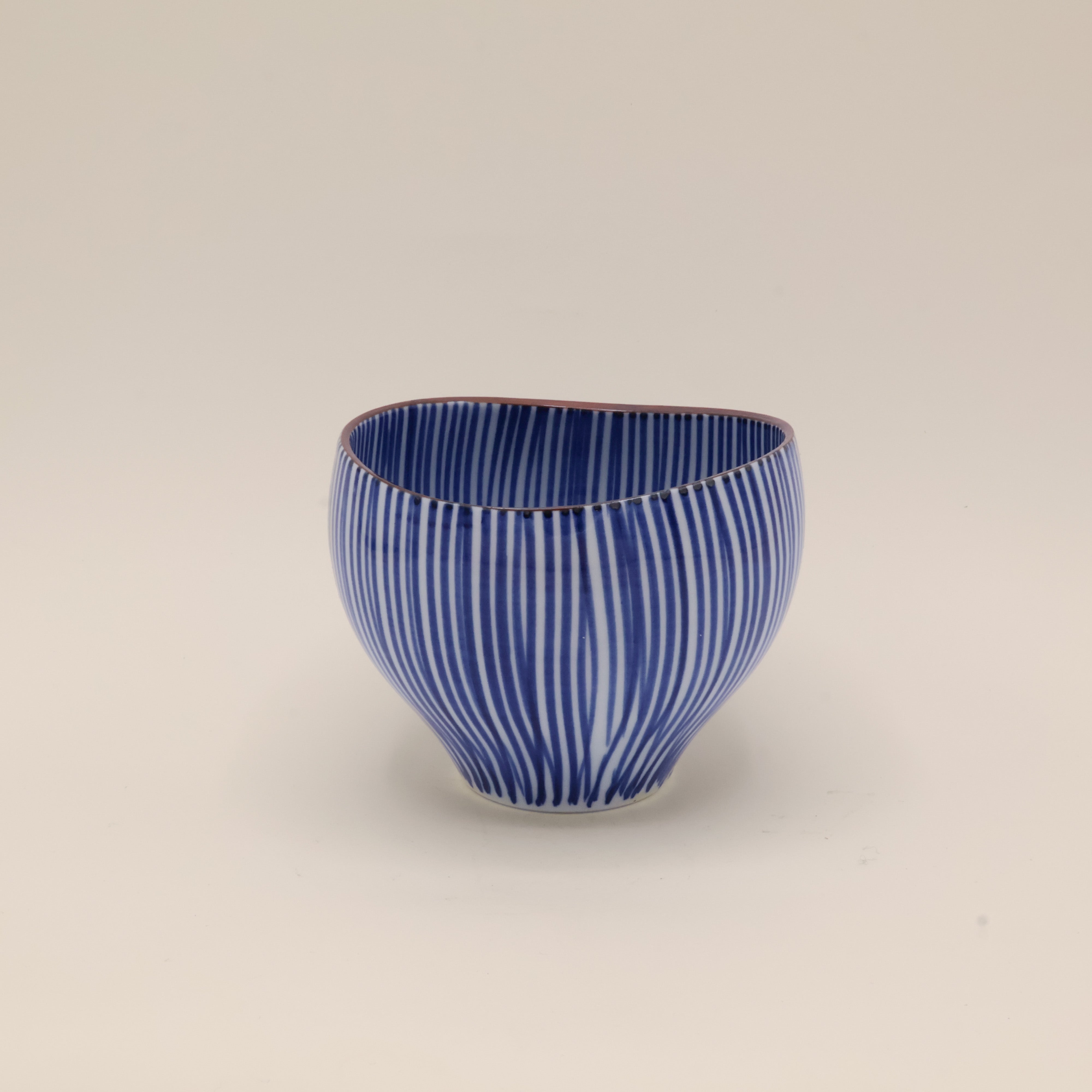 Cup with blue vertical stripes and brown rim