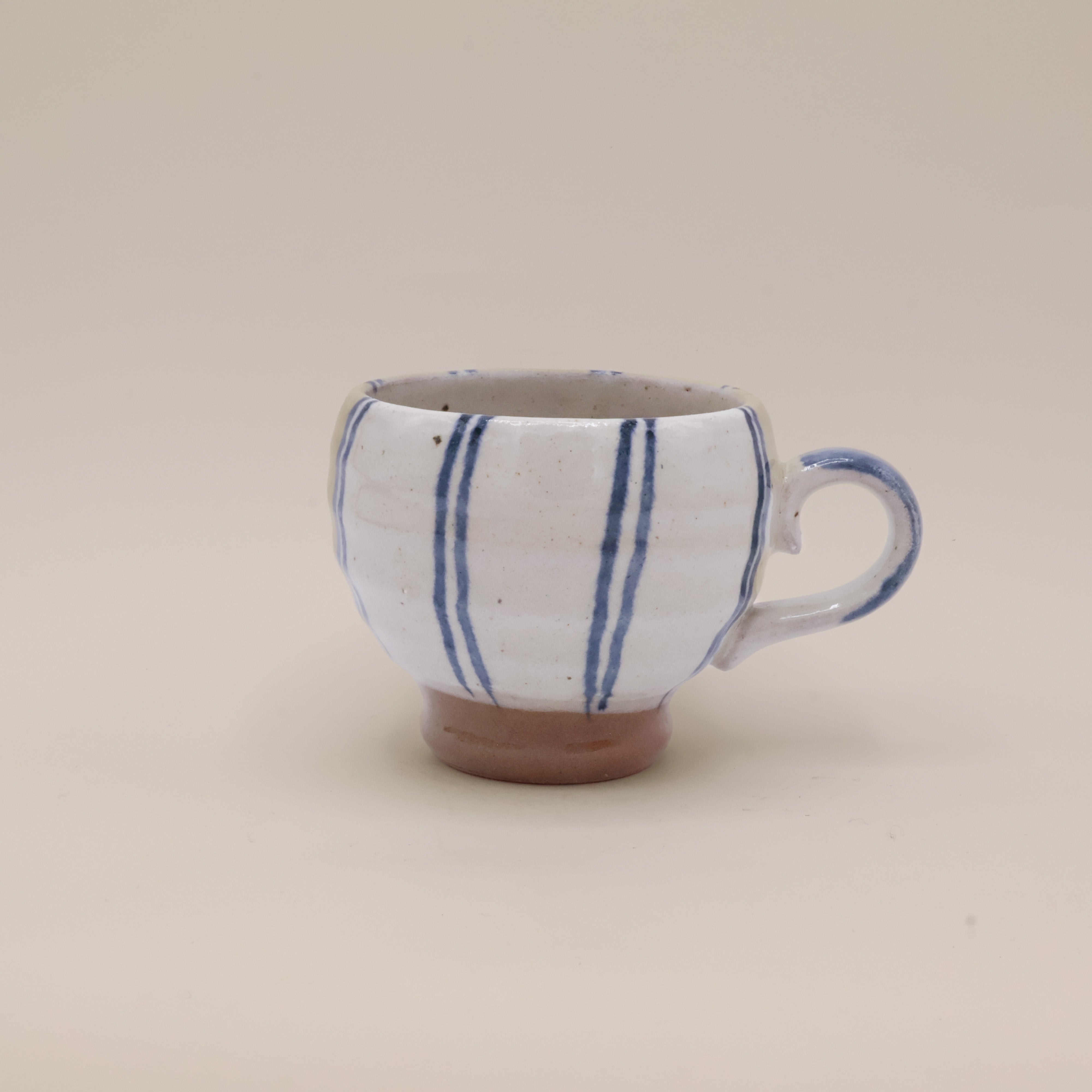 Hand painted ceramic cup with blue stripes