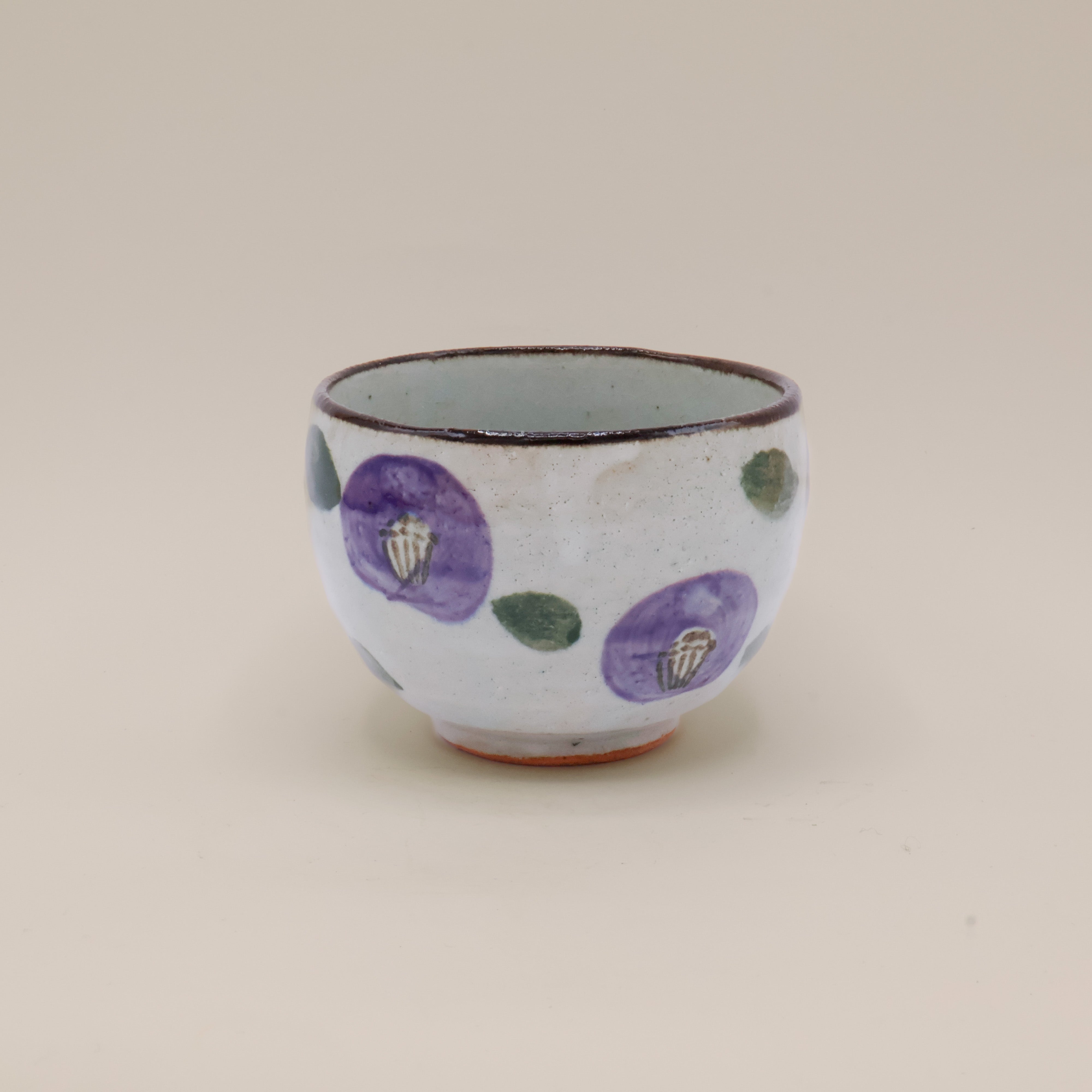 Cup with purple flowers and brown rim