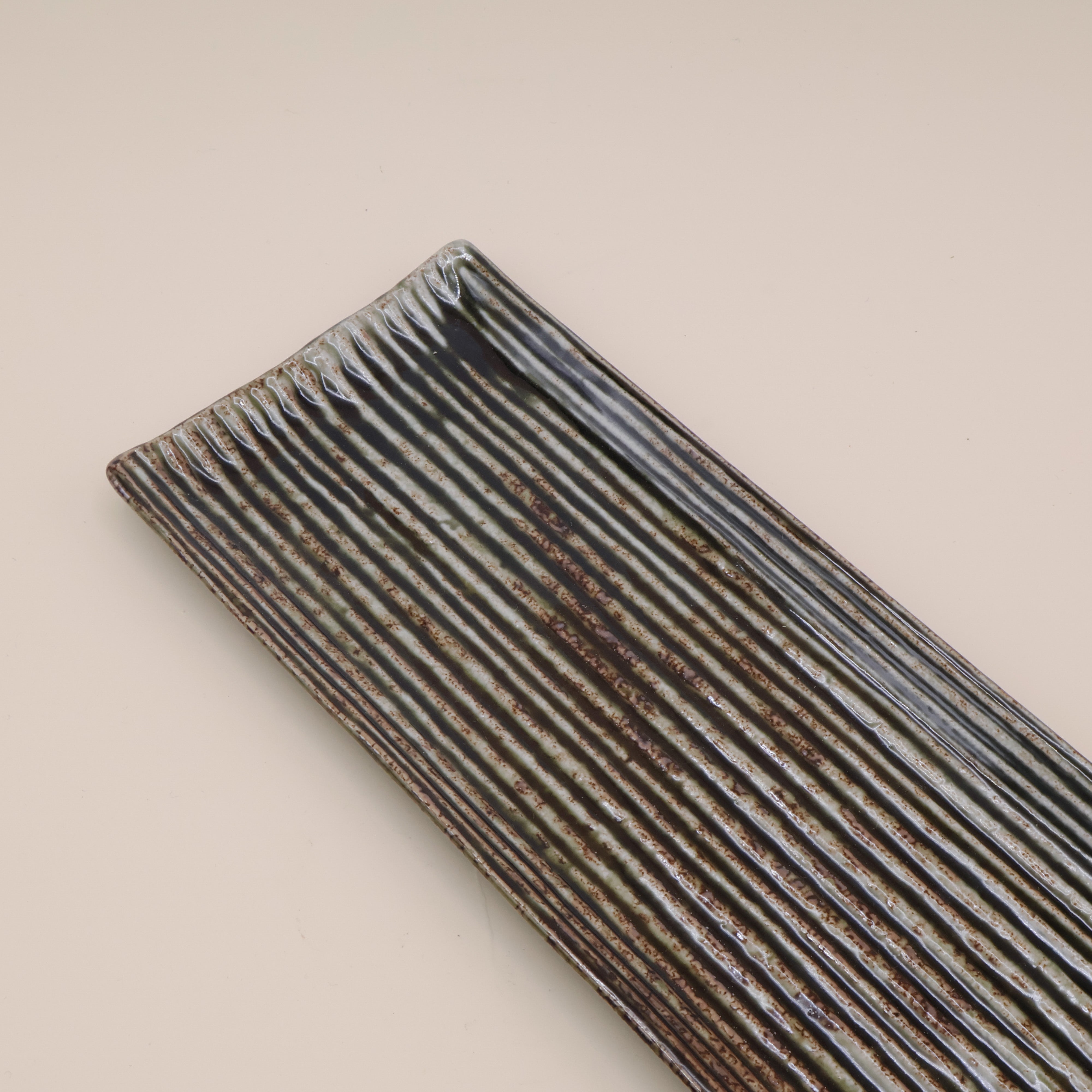 Oblong green dish with stripes