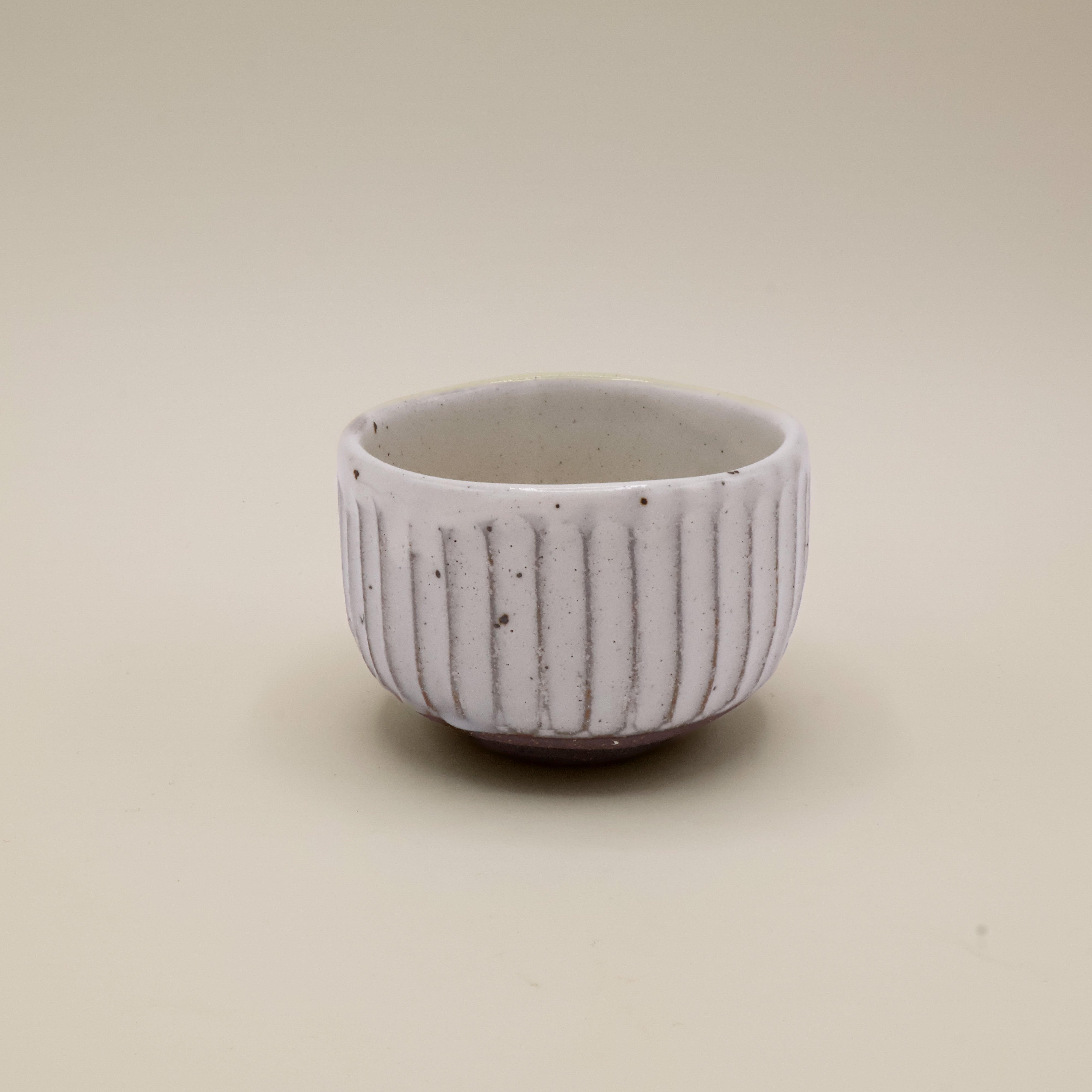 White cup with stripes and grooves