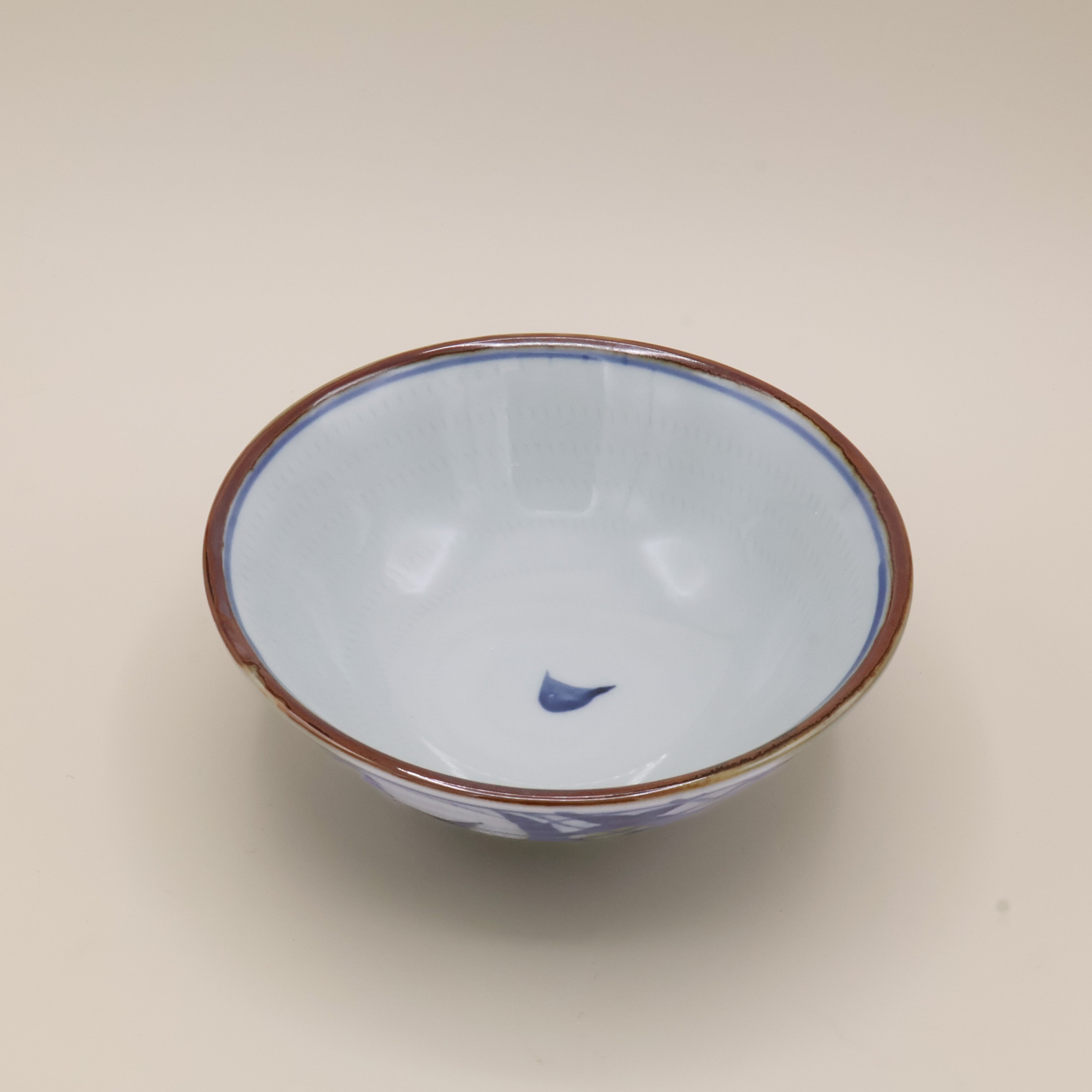 Noodle bowl with blue motif and brown rim