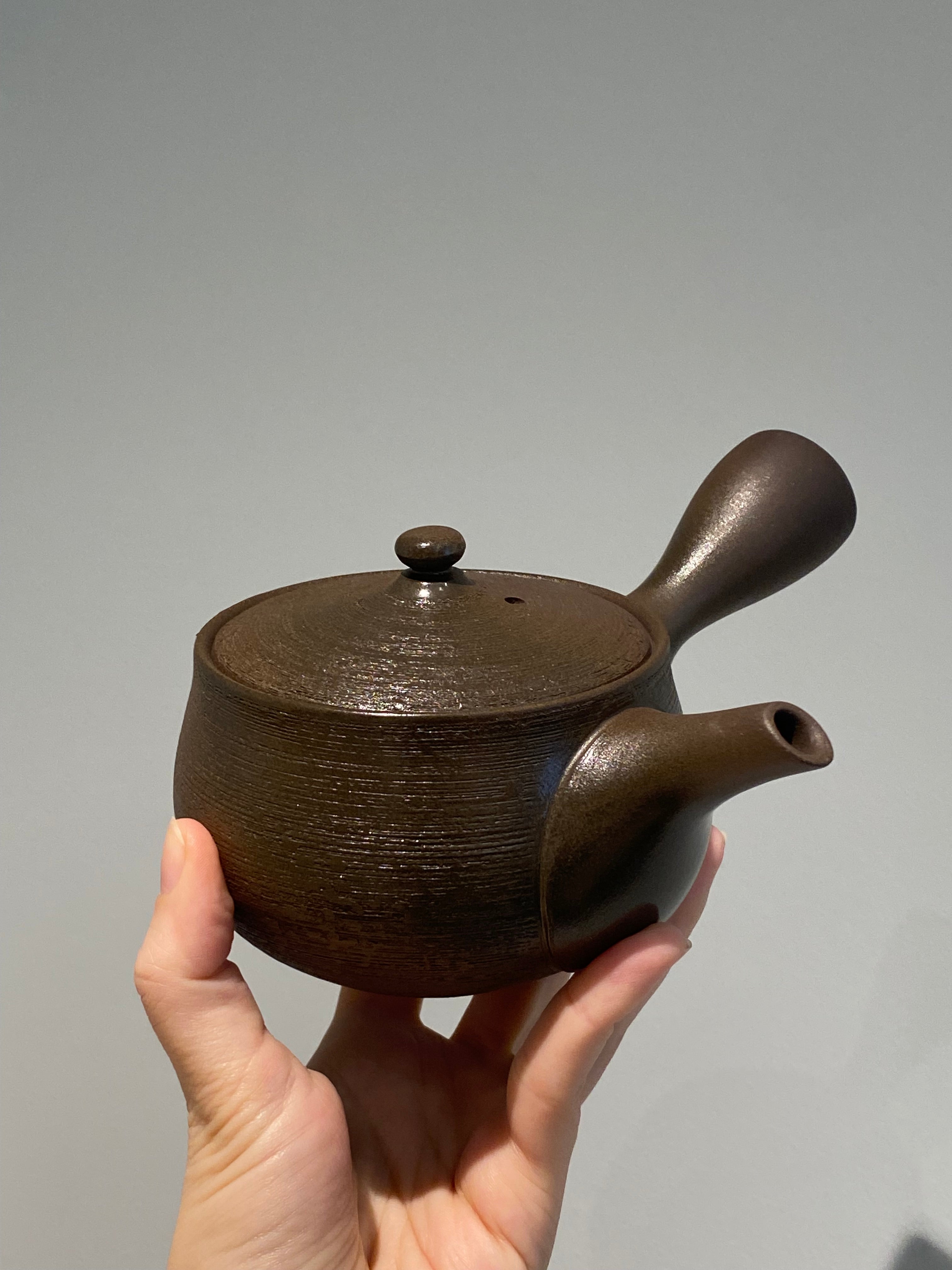 Rustic dark brown teapot with handle