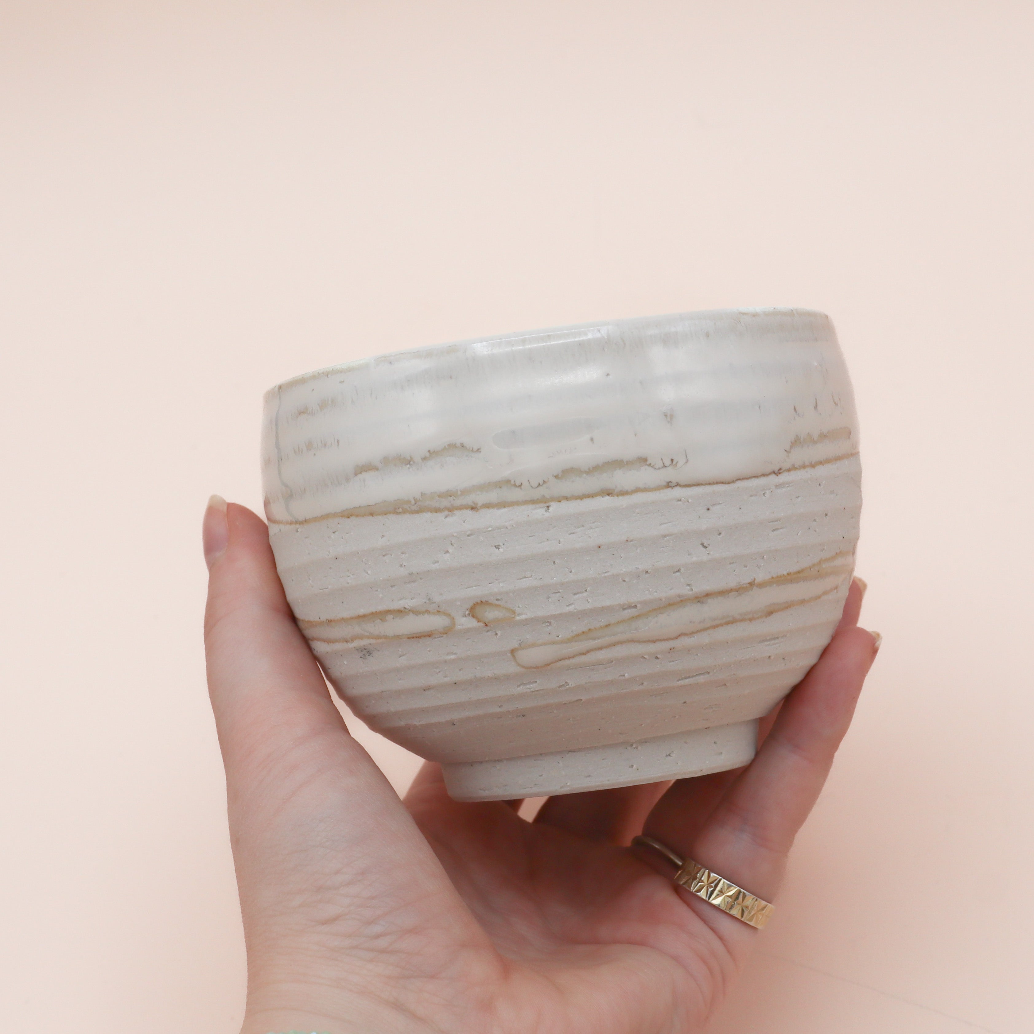 White cup with rustic surface and white glaze