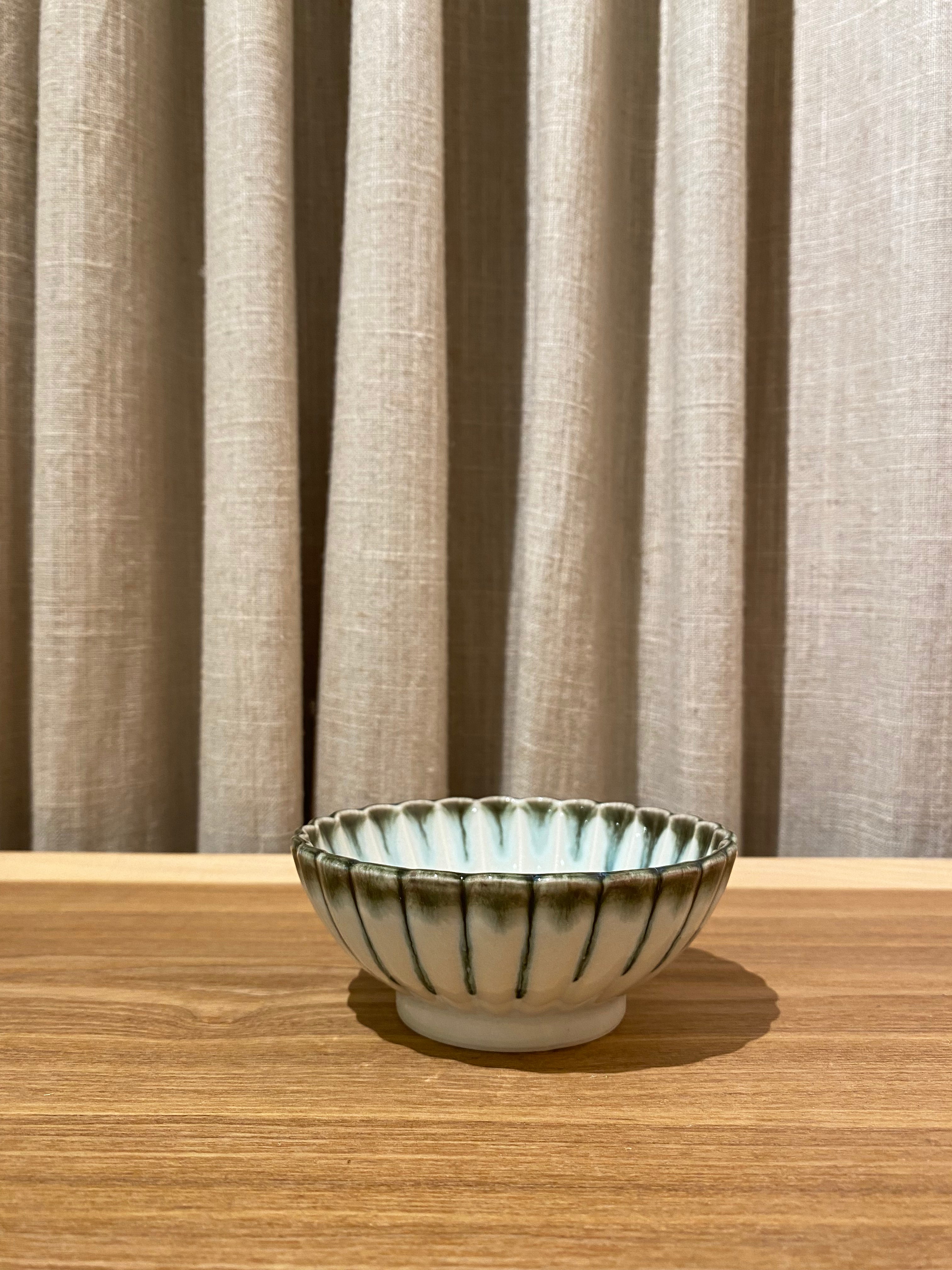 Light blue flower bowl with green rim