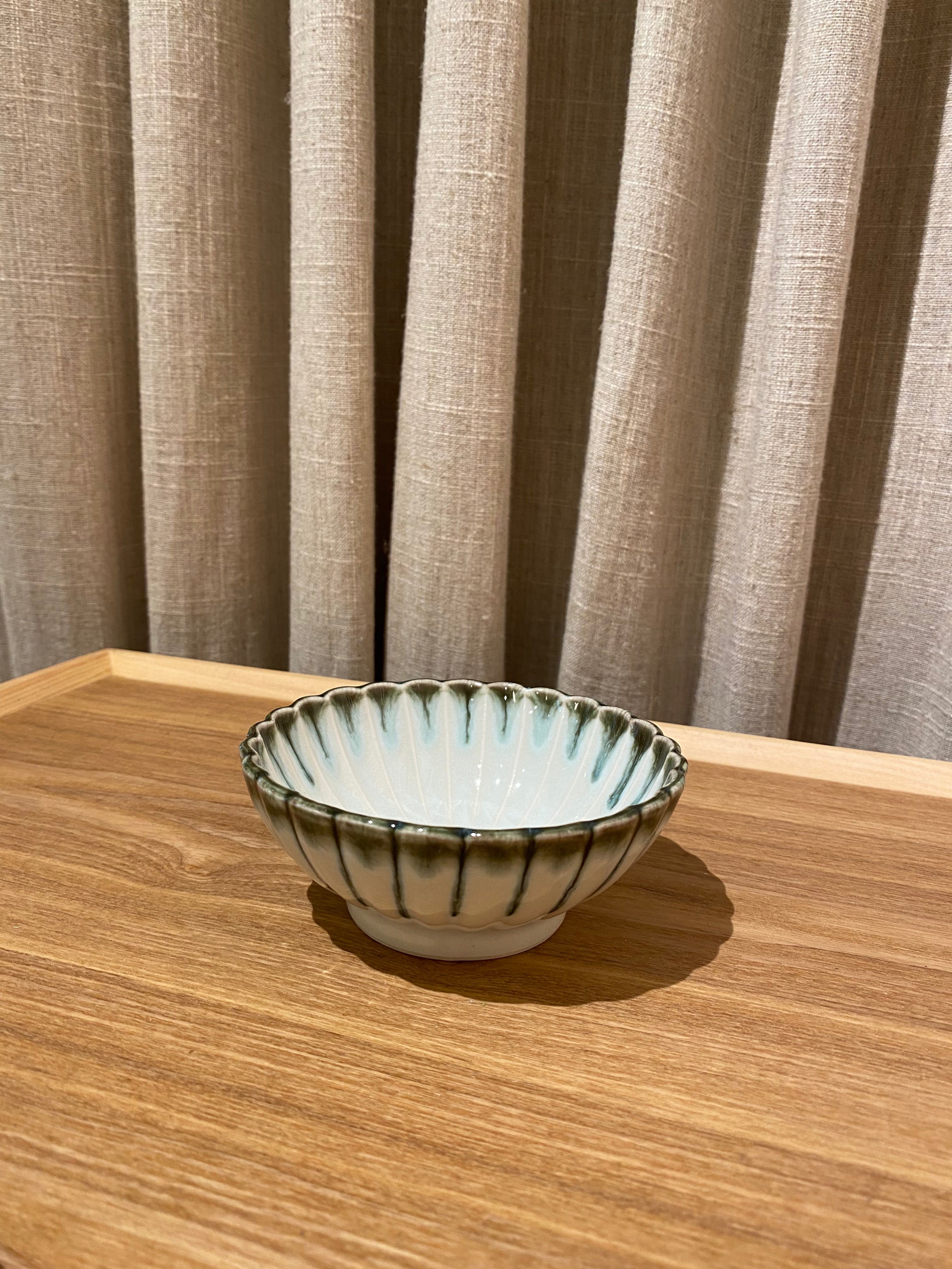 Light blue flower bowl with green rim