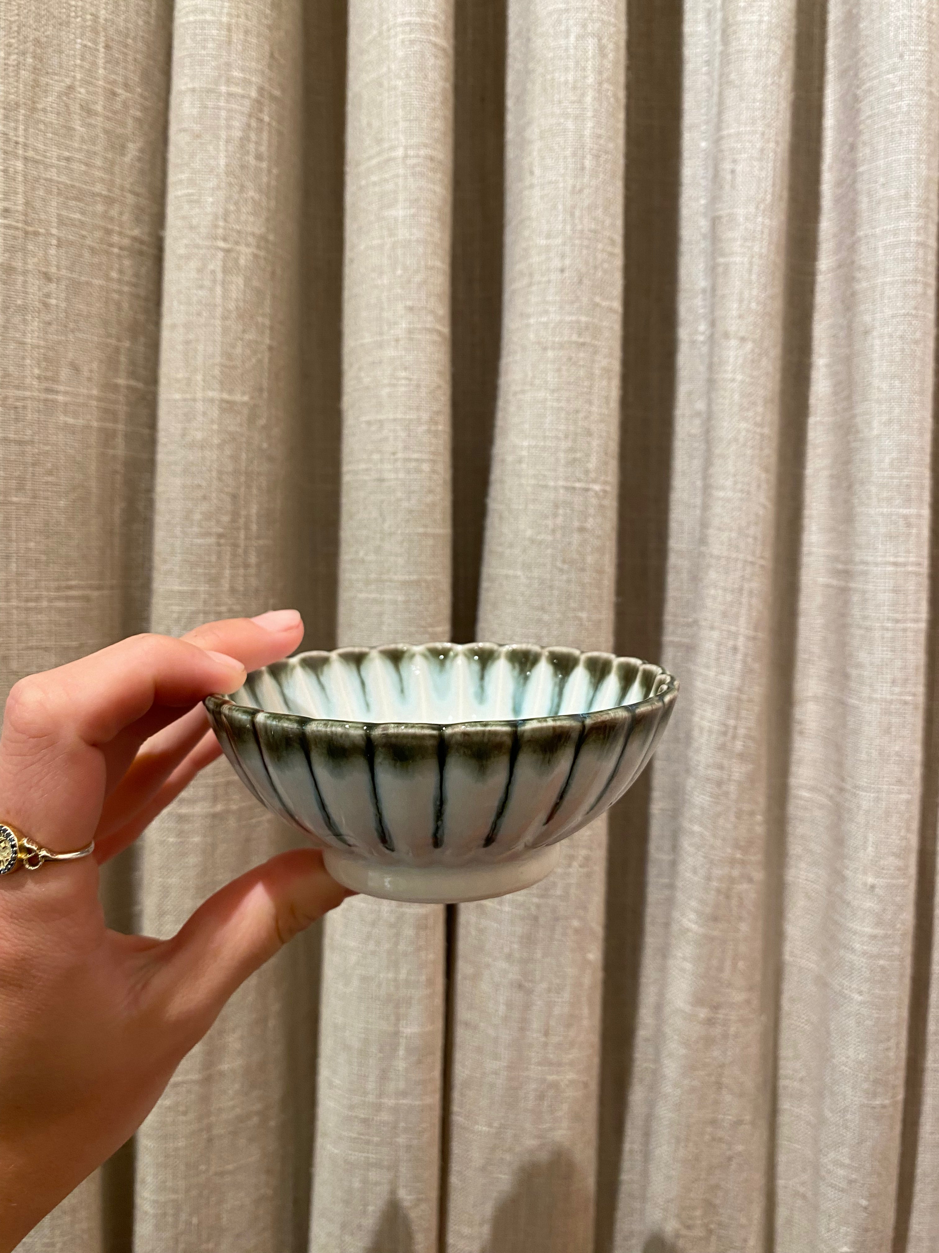 Light blue flower bowl with green rim