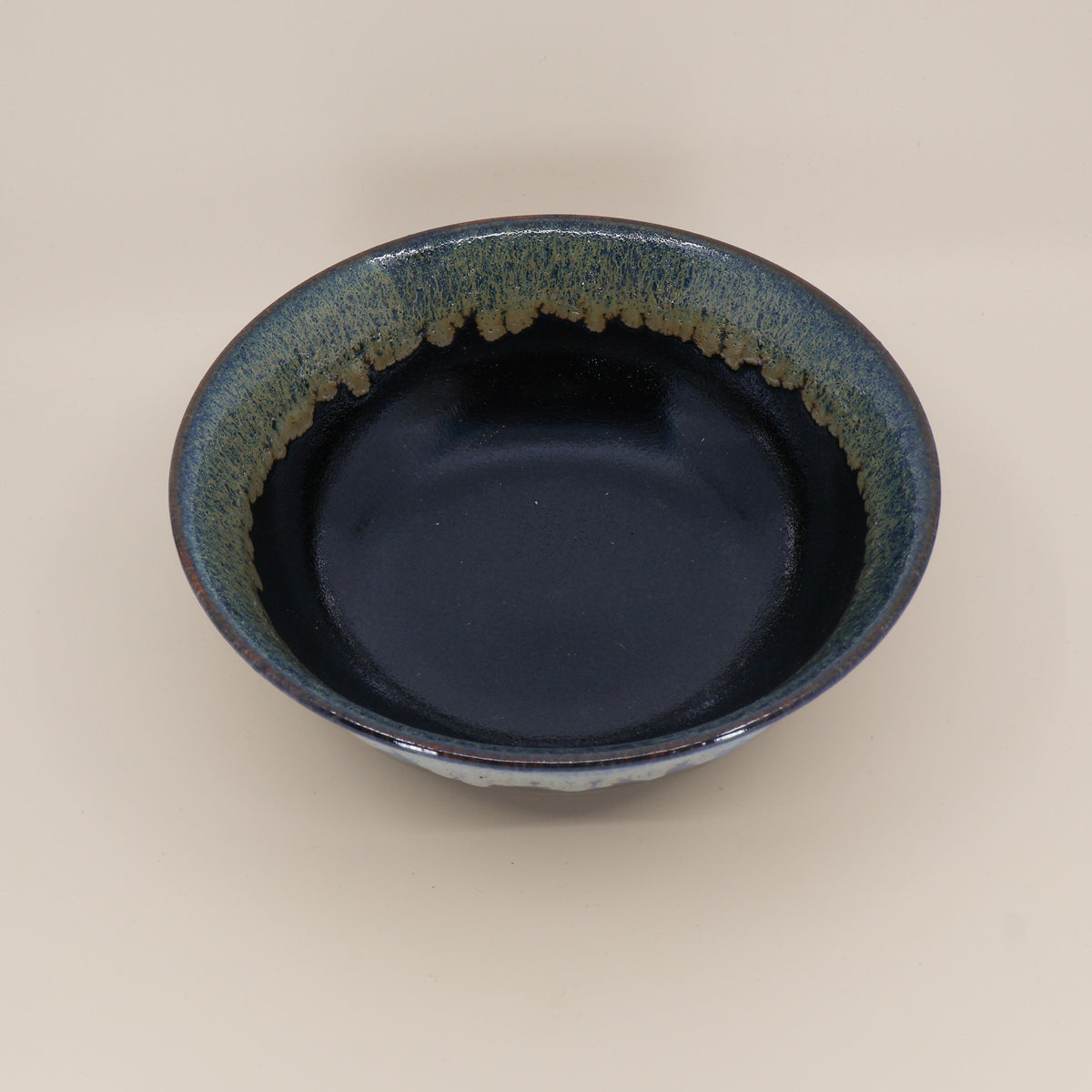 Black ramen bowl with running green and blue glaze
