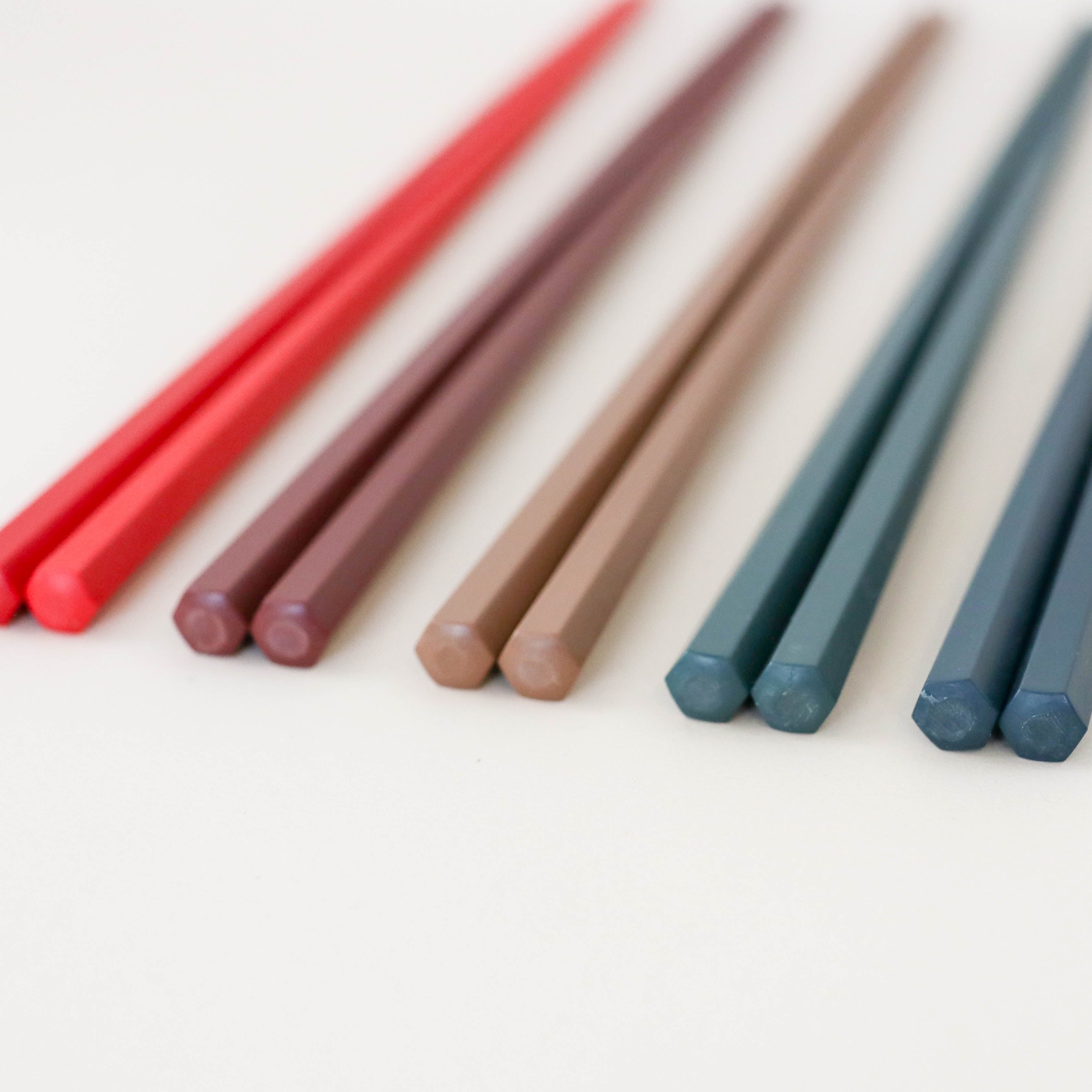 Chopsticks in red, brown and blue colors