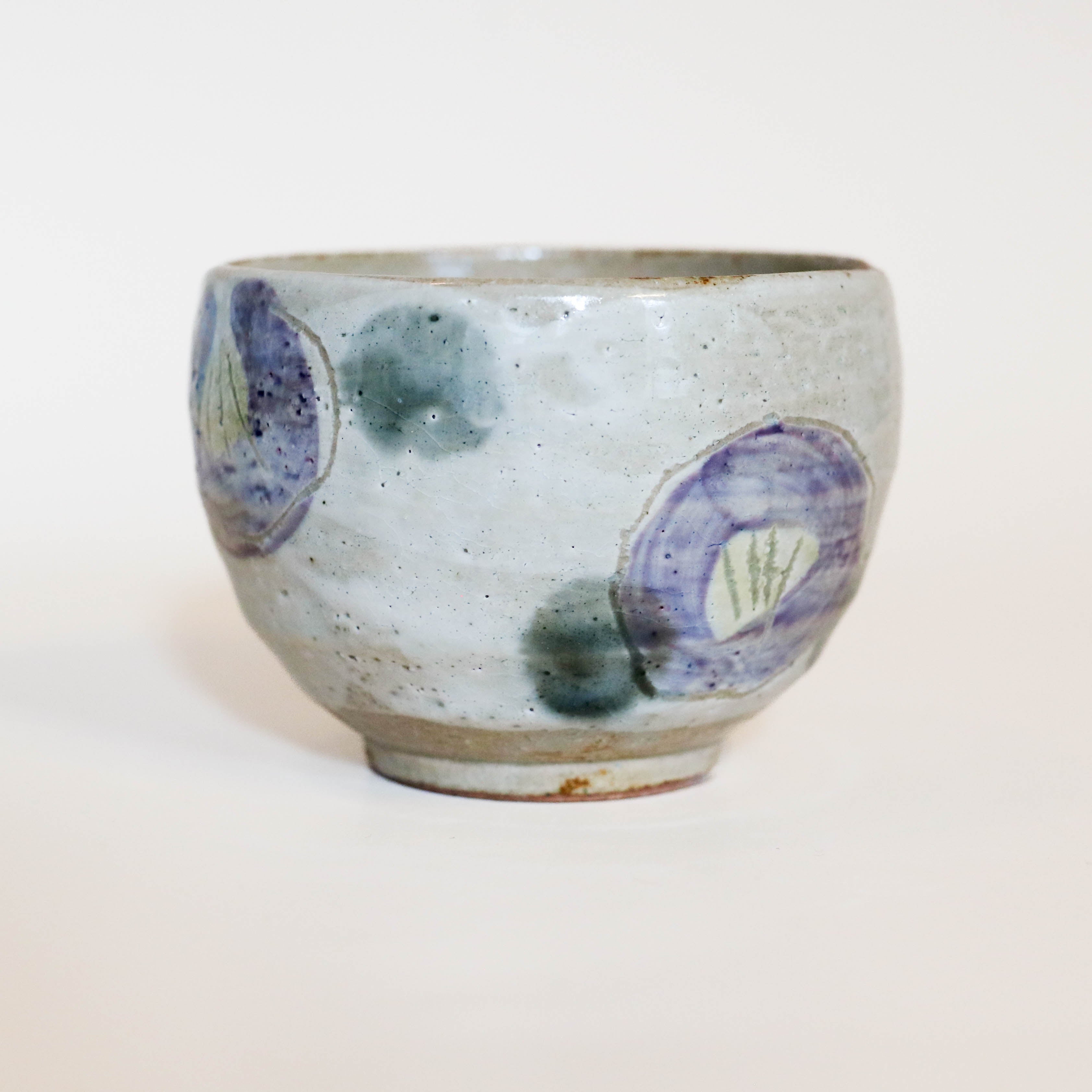 Cup with purple flowers and green dots
