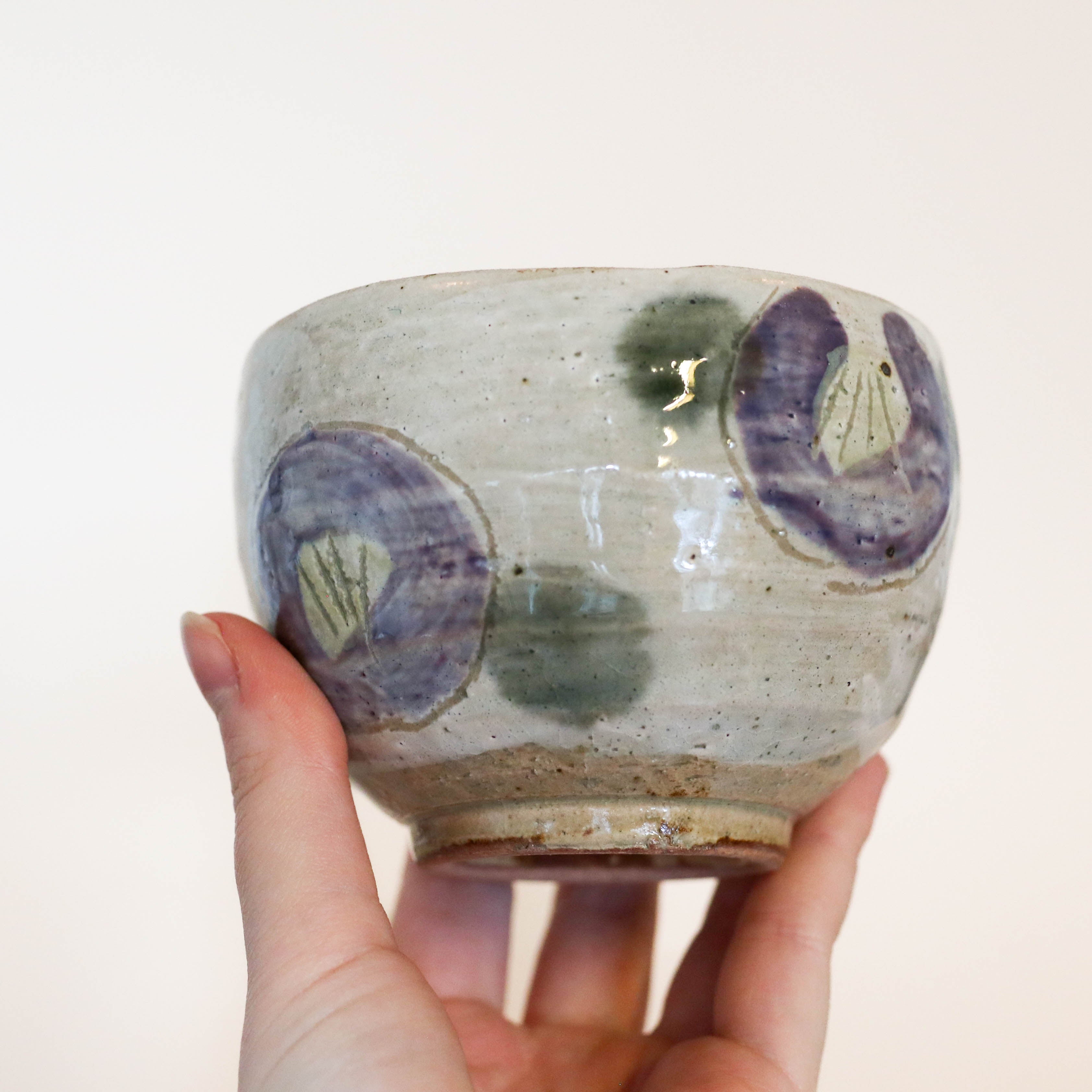 Cup with purple flowers and green dots