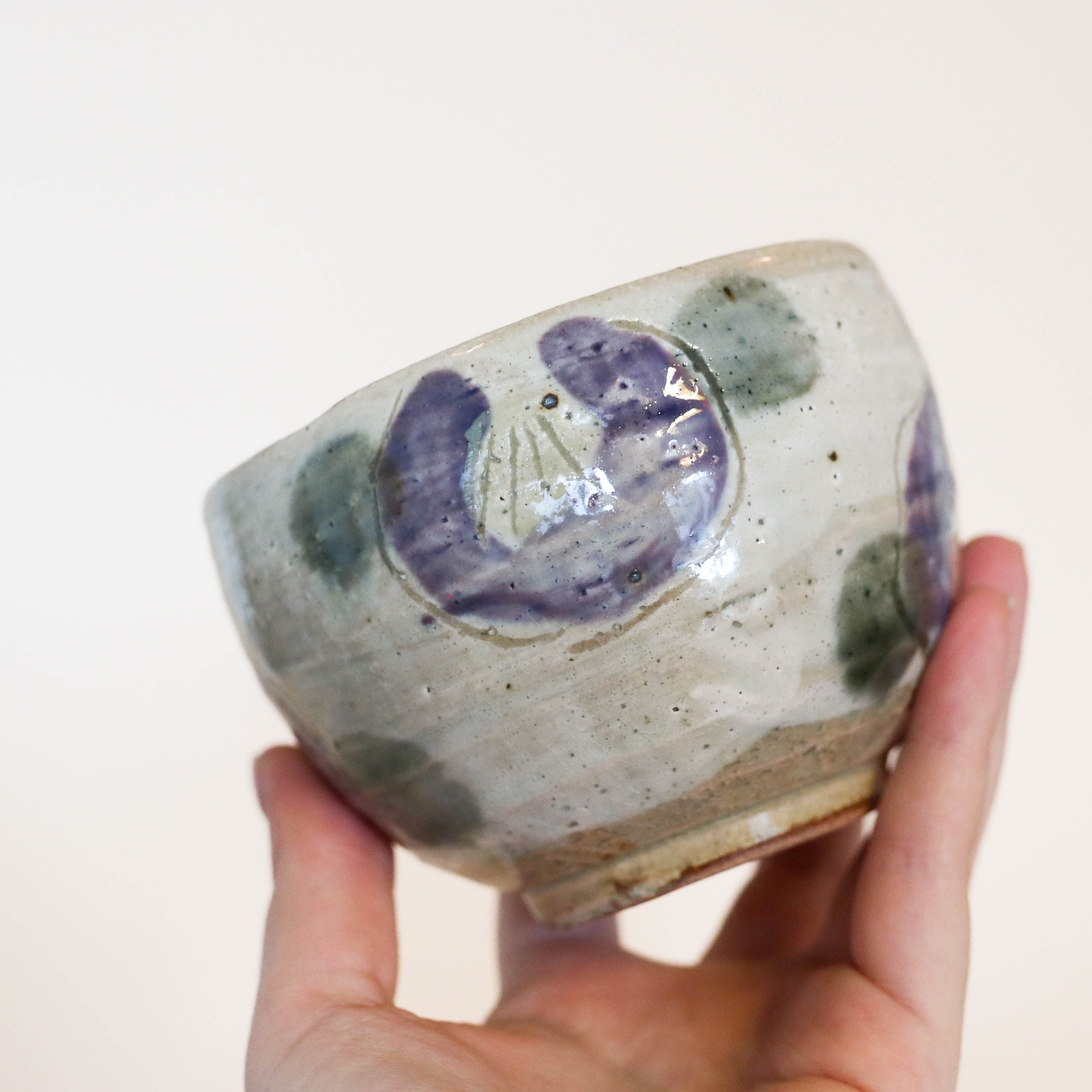 Cup with purple flowers and green dots