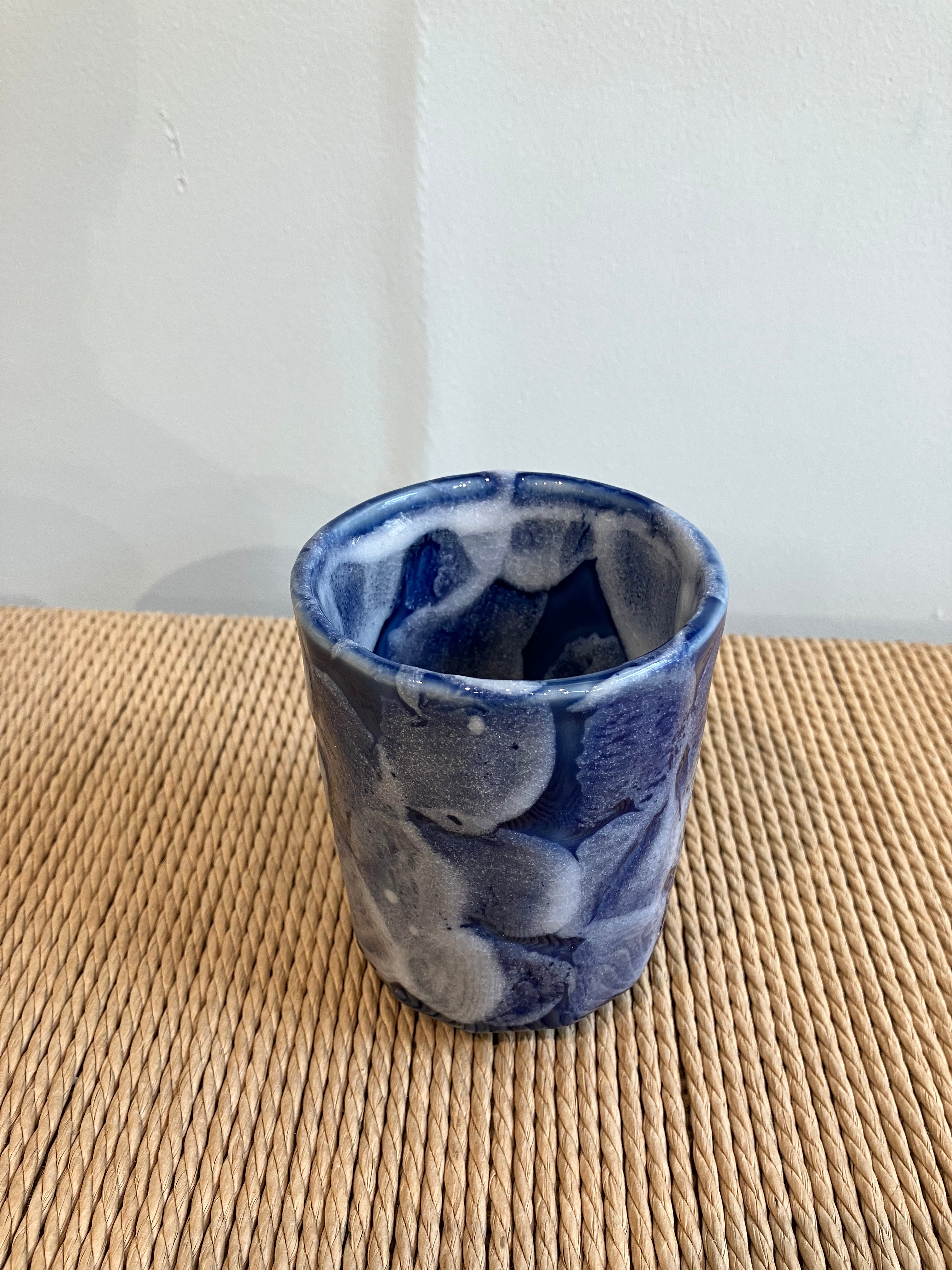 Ceramic cup with blue glaze and white details