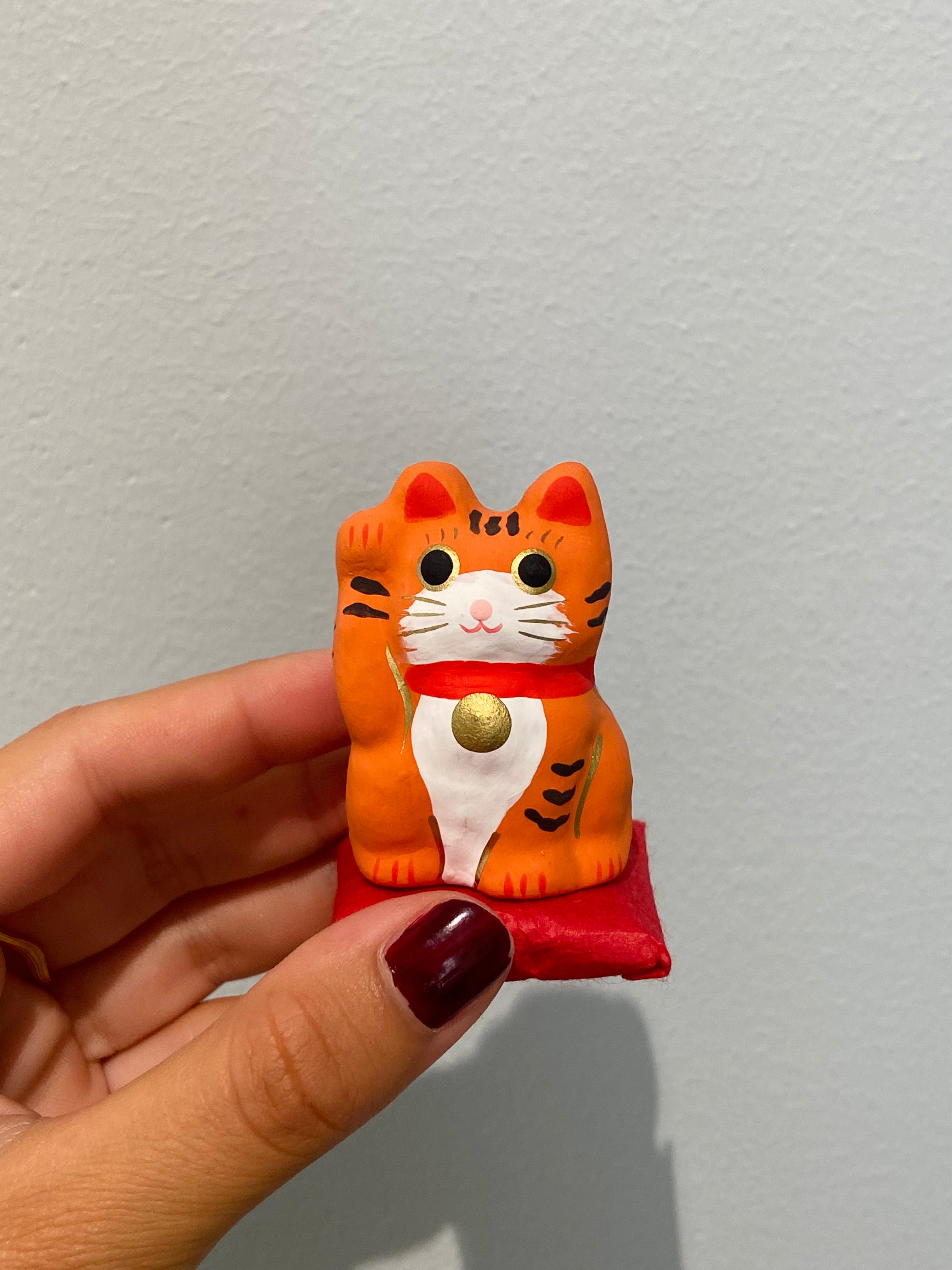 Lucky Cat on pillow, orange
