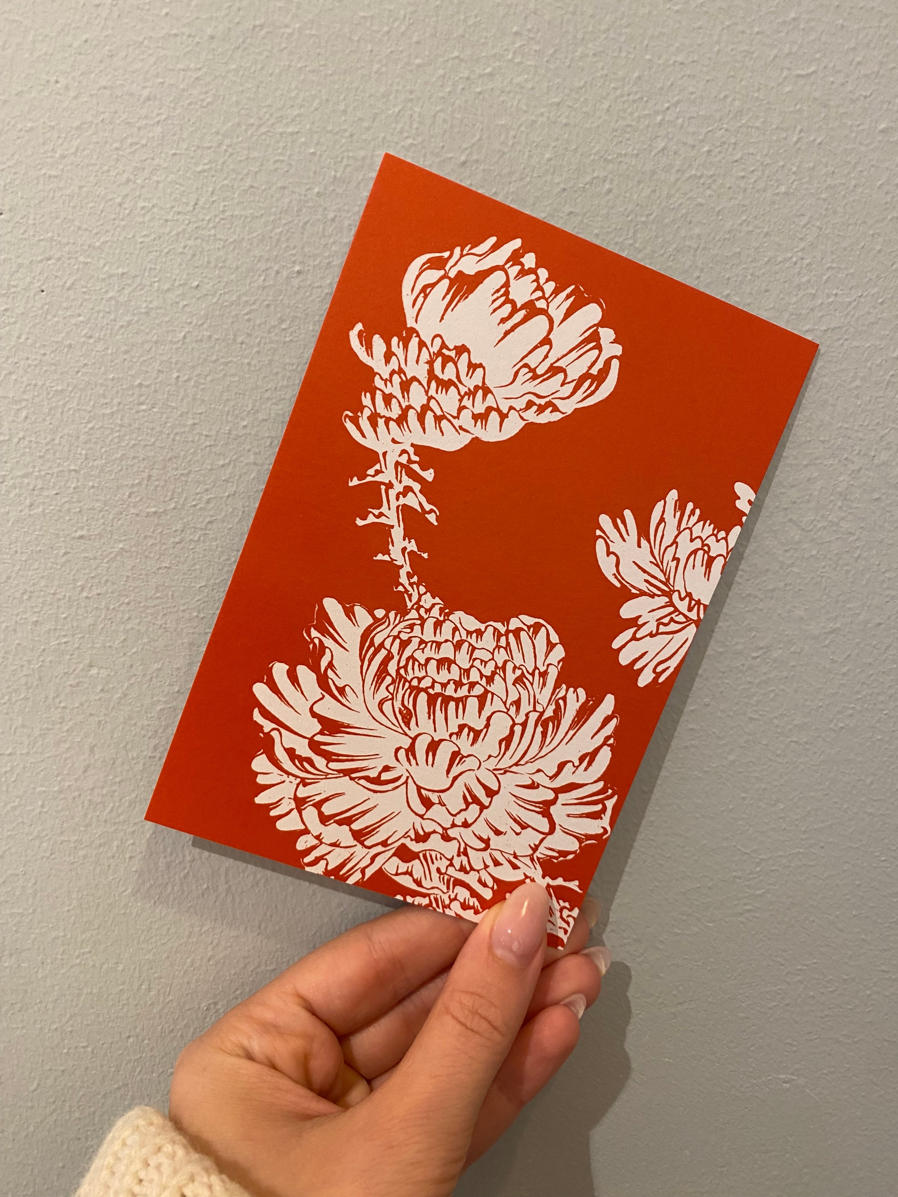 Japanese postcard with white flowers on a red background