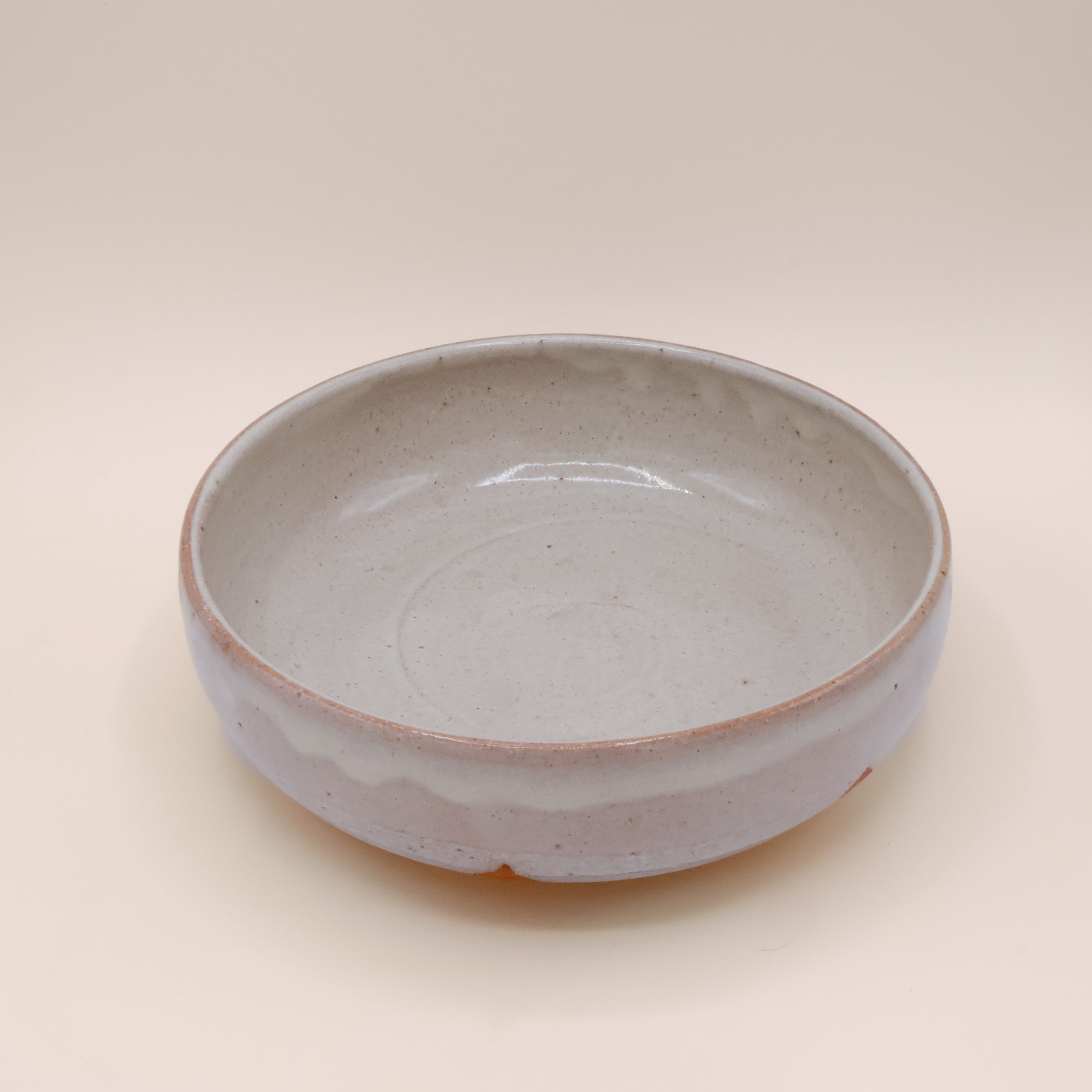 Fad i grå glasur og lyserødt skær
