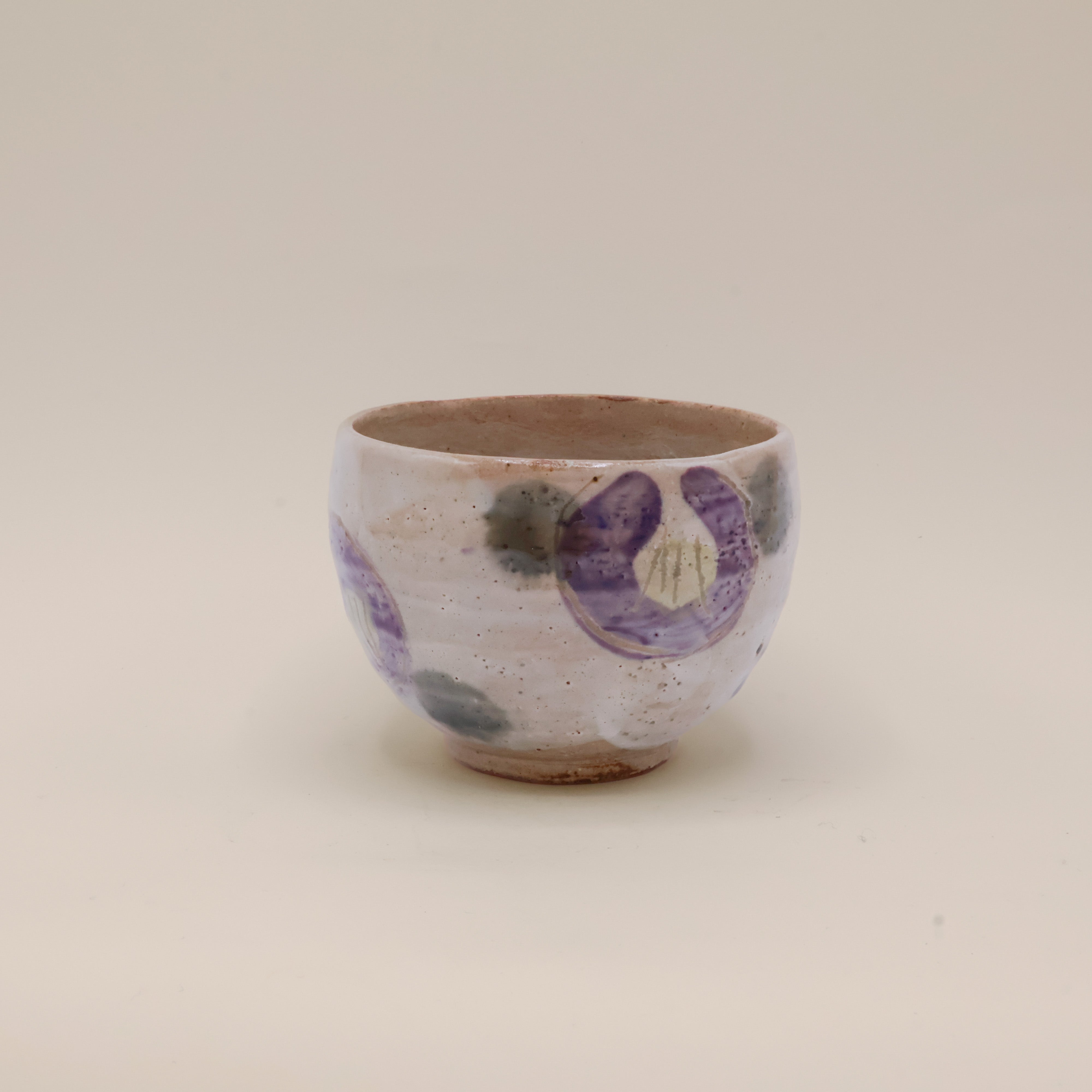 Cup with purple flowers and green dots
