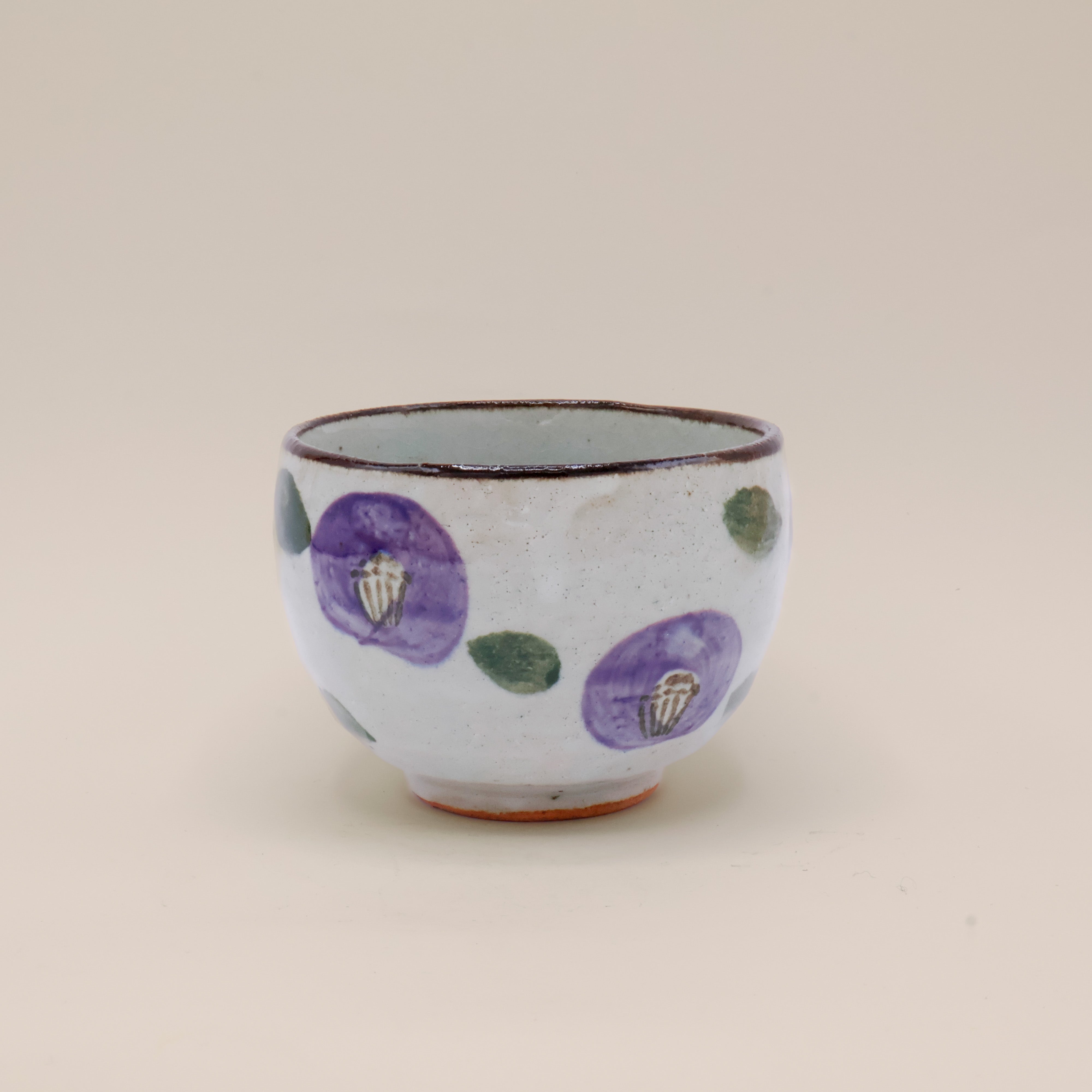 Cup with purple flowers and brown rim