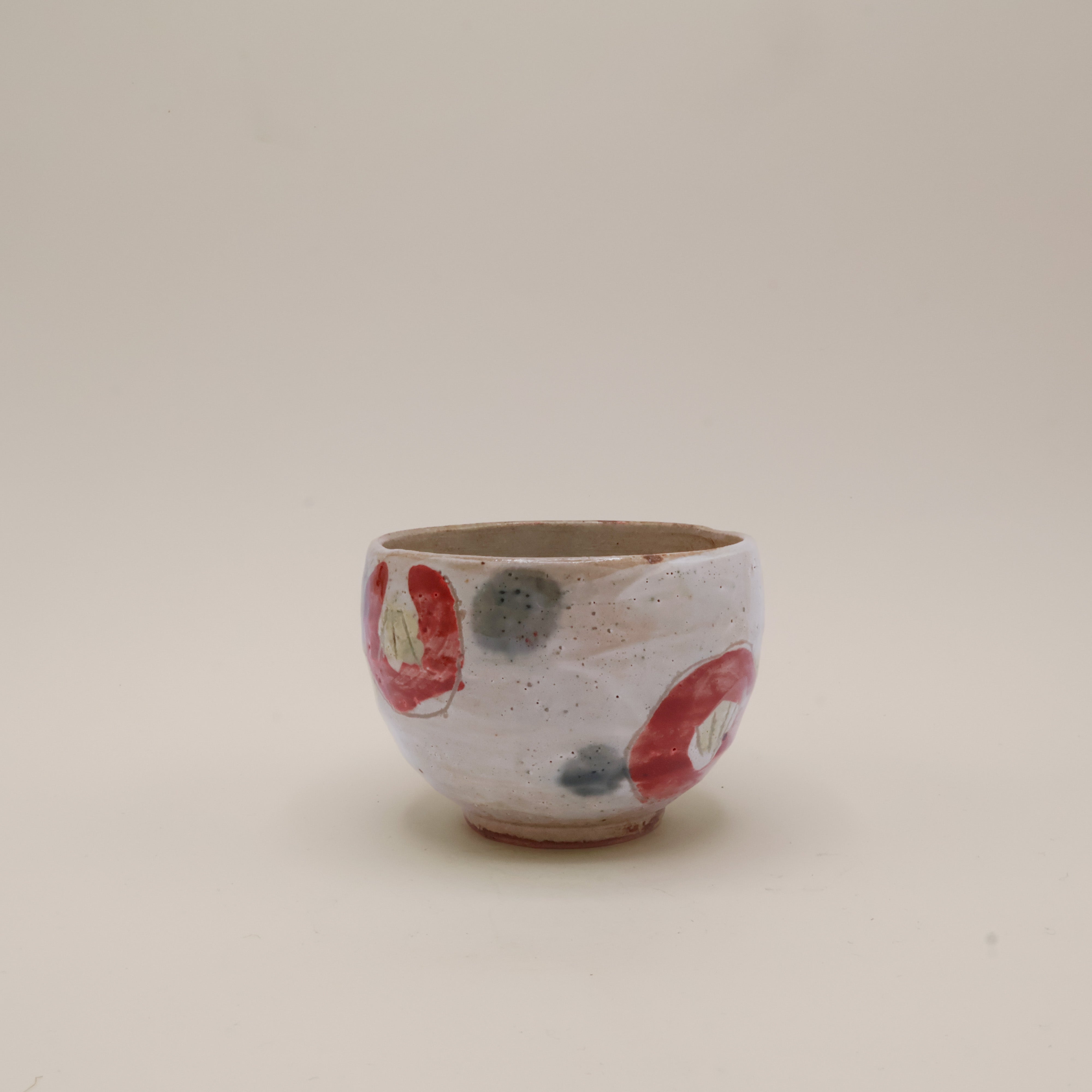 Cup with red flowers and green dots