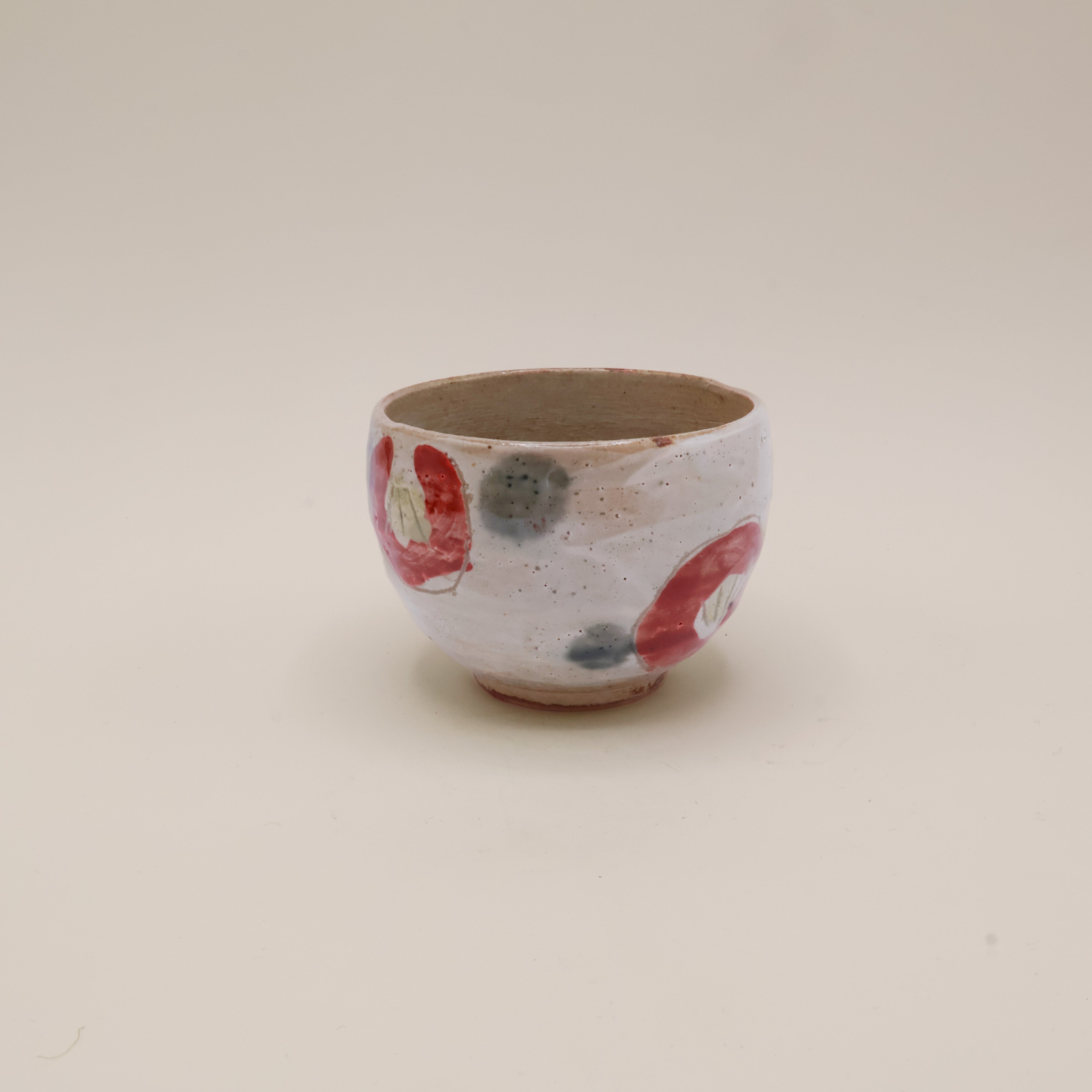 Cup with red flowers and green dots