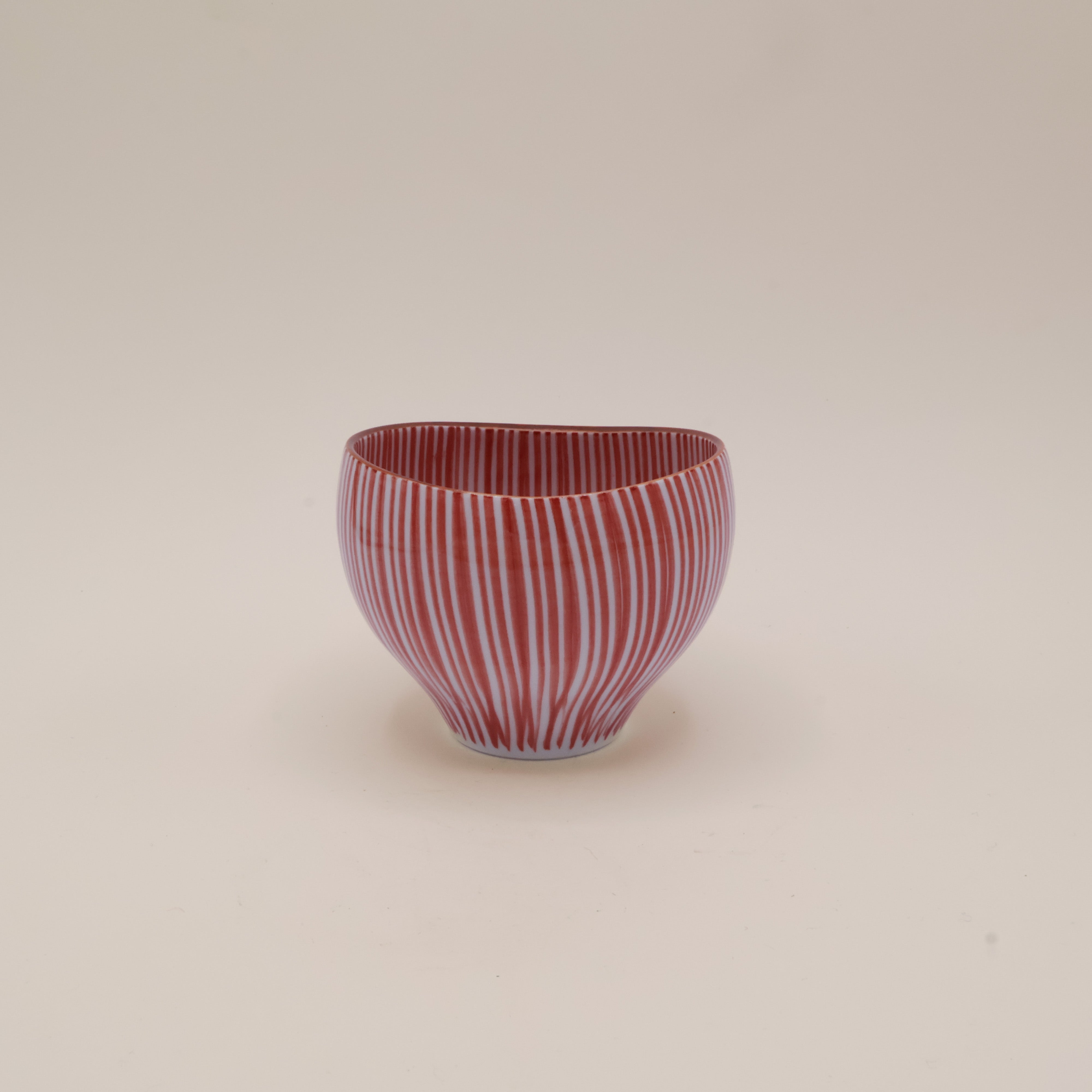 Cup with red vertical stripes and brown rim