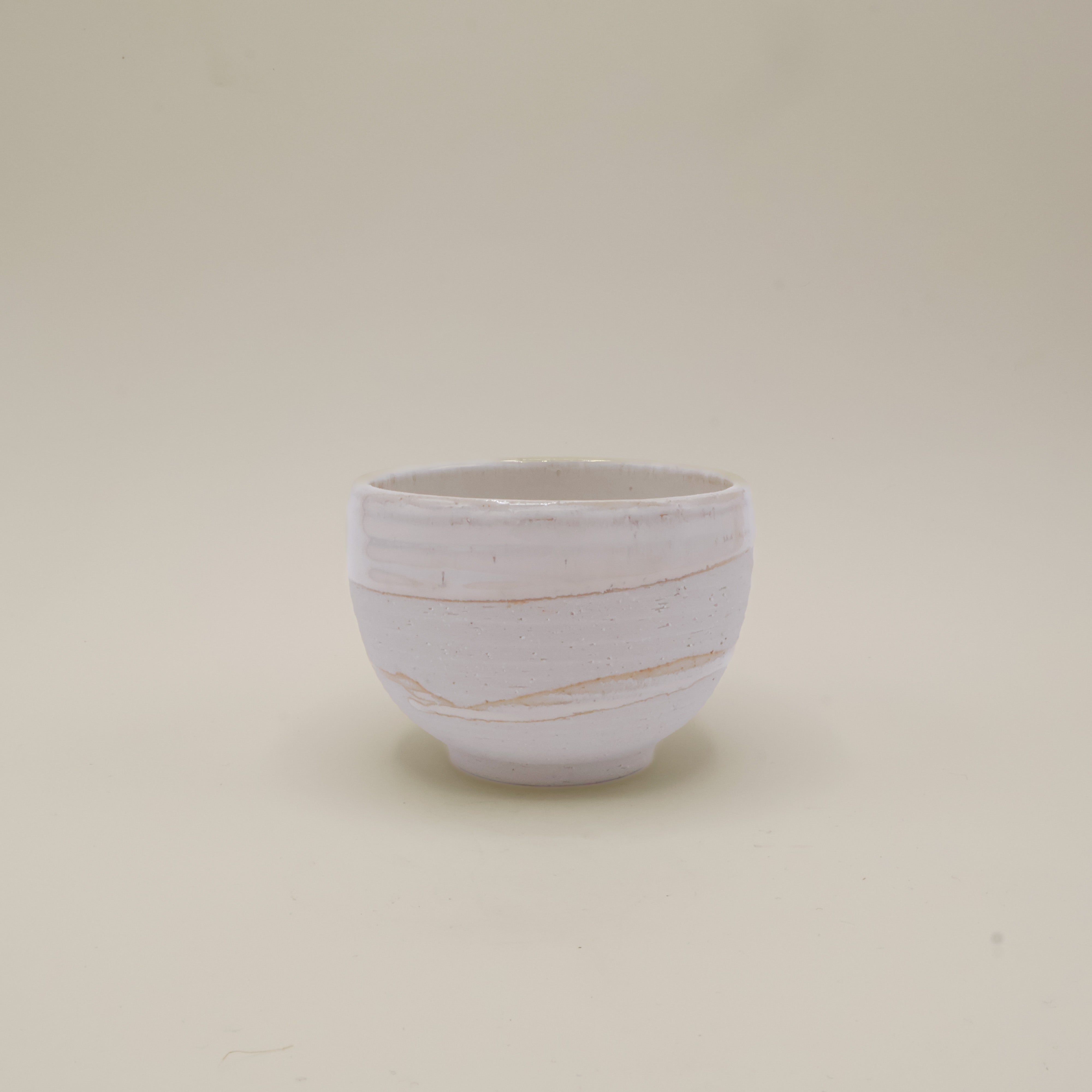 White cup with rustic surface and white glaze