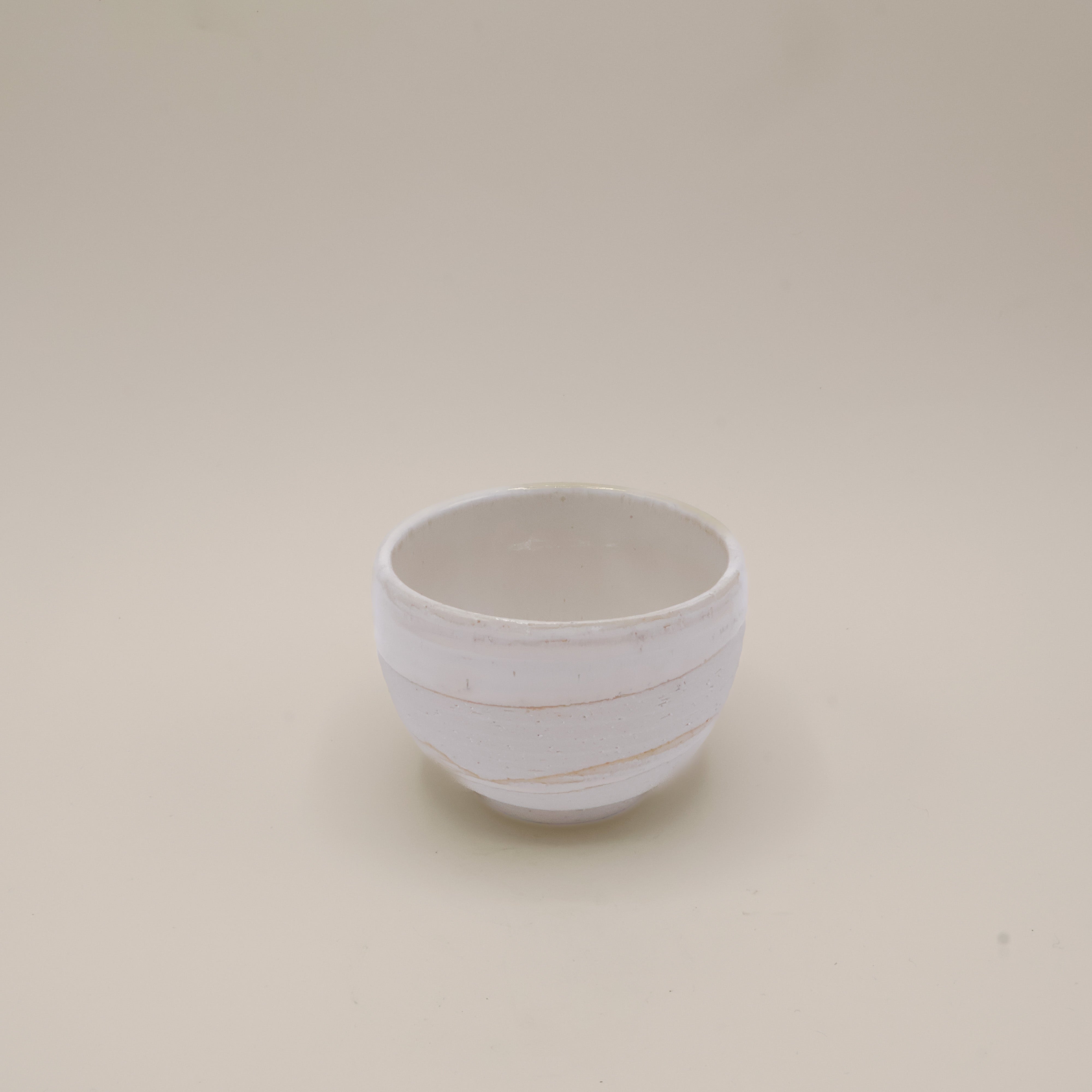 White cup with rustic surface and white glaze