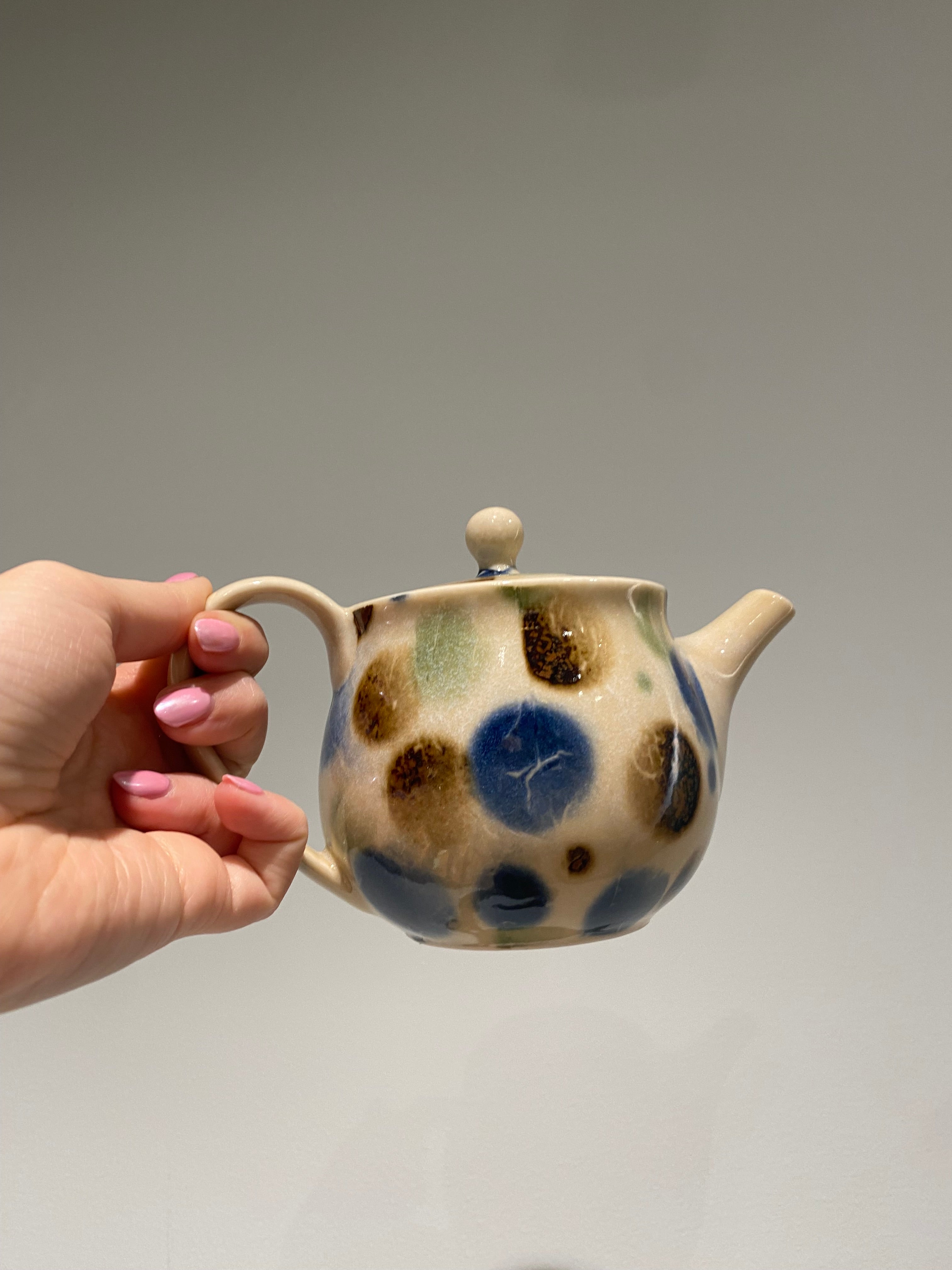Small teapot with blue, brown and green dots