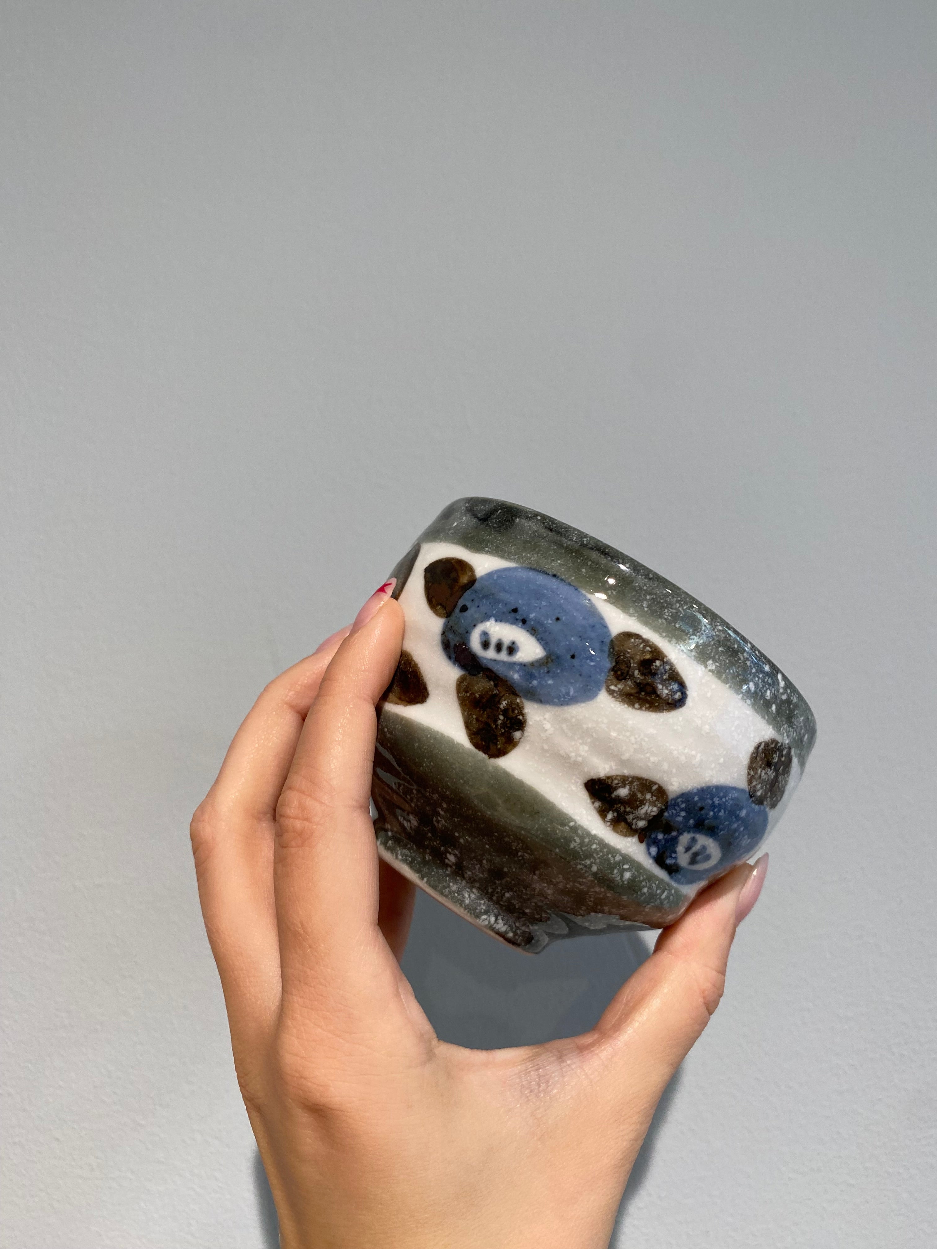 Japanese cup with flowers in blue, brown and gray details