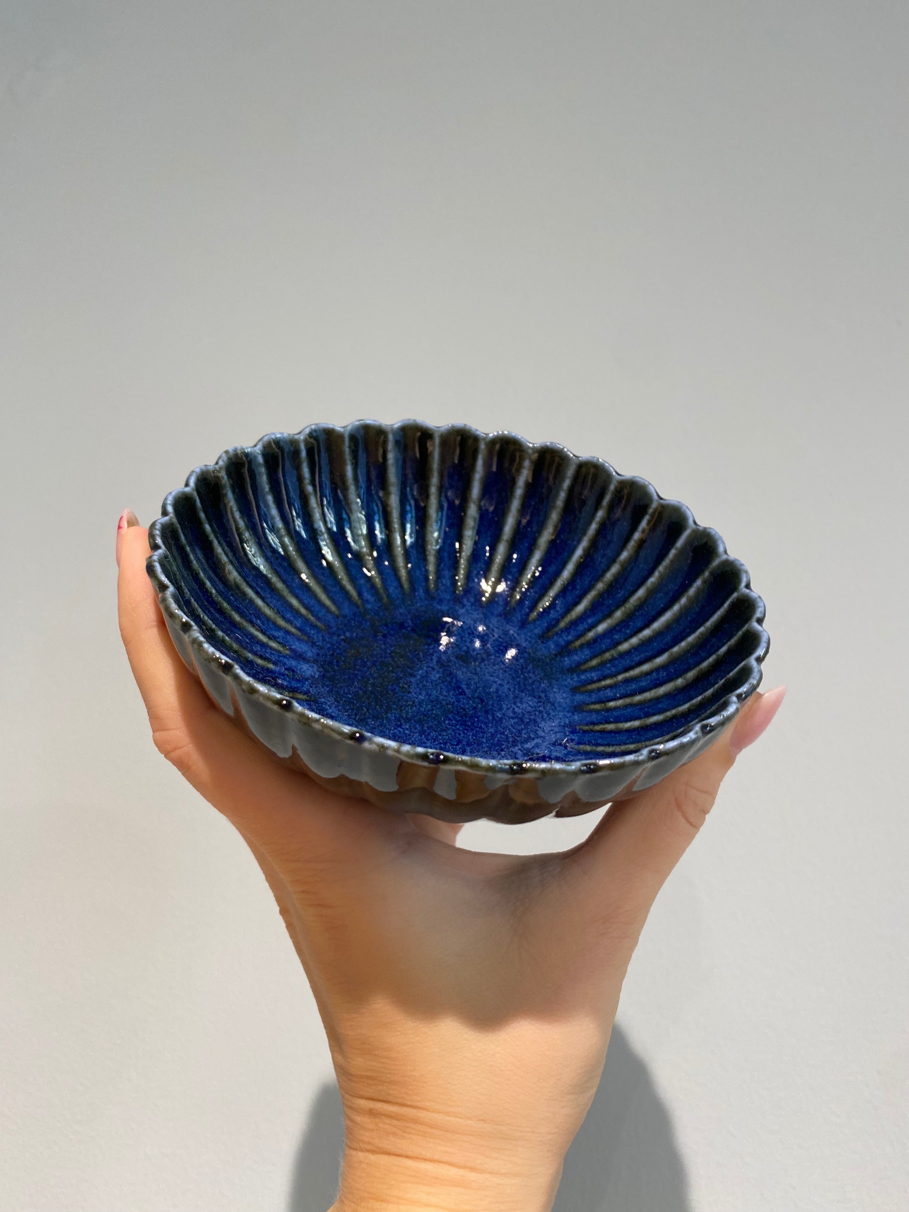 Flower-shaped bowl with dark blue glaze