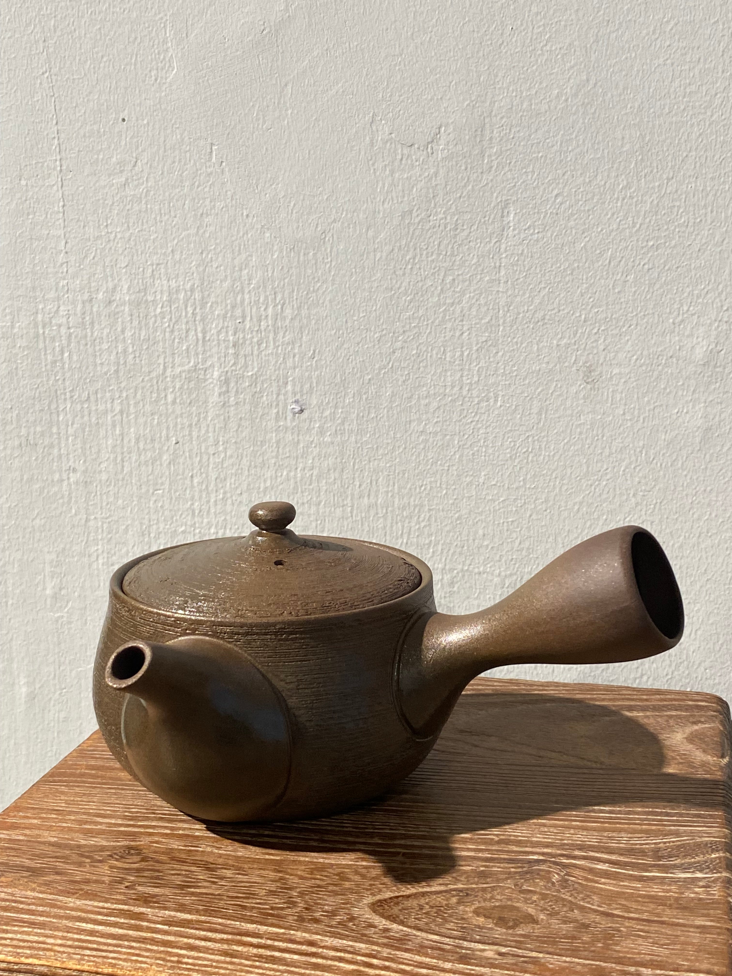 Rustic dark brown teapot with handle