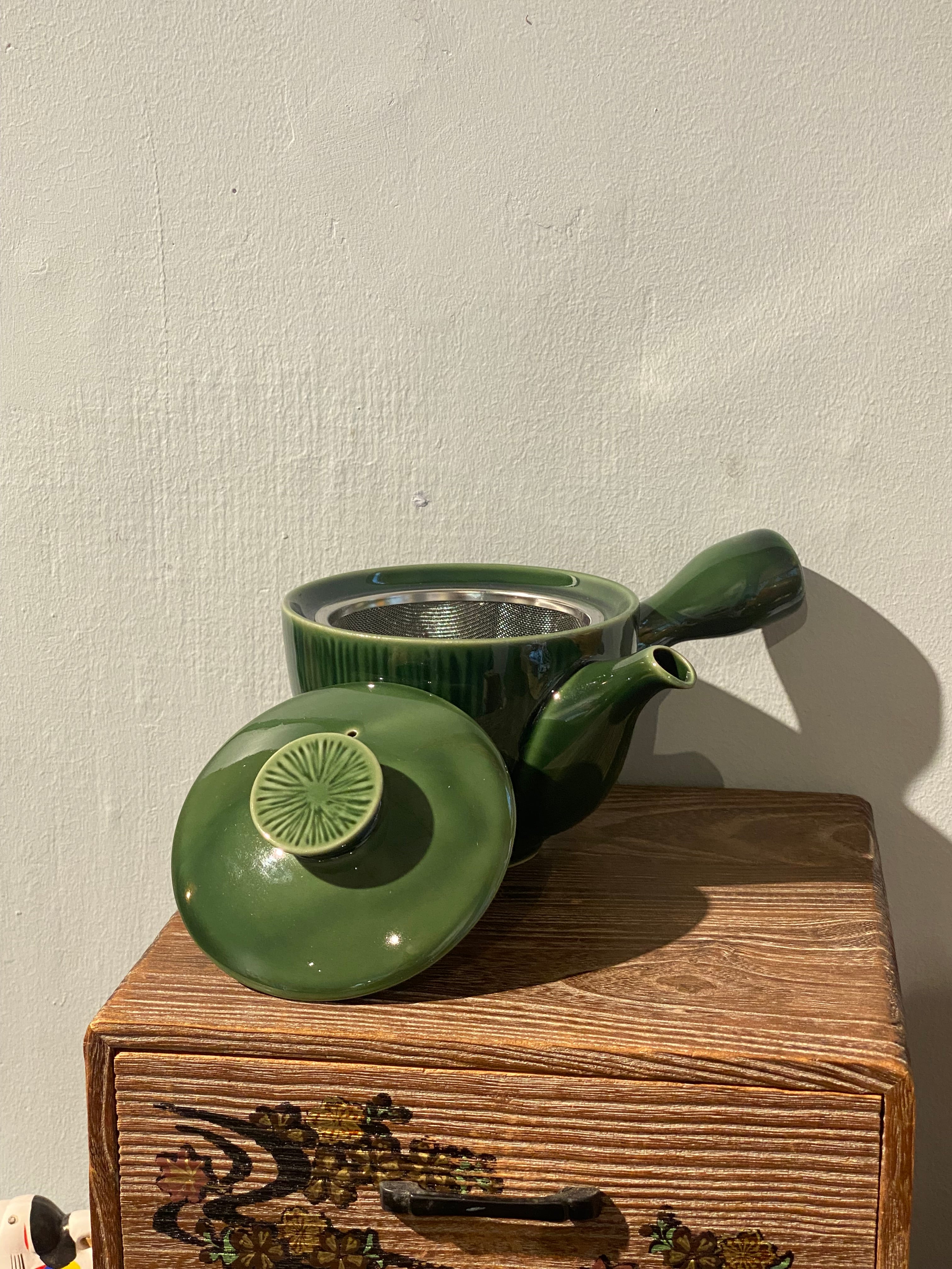 Glossy green teapot with handle