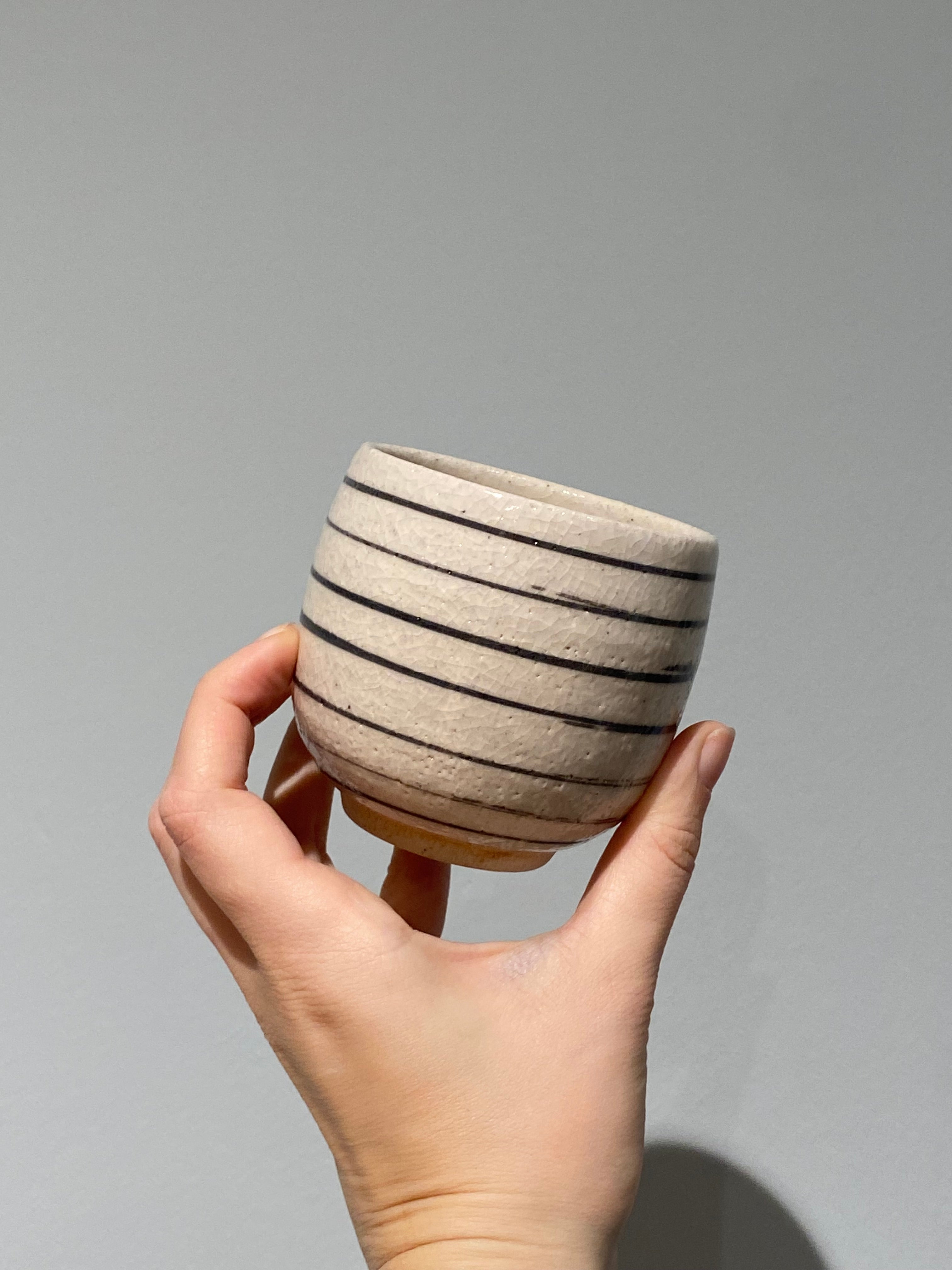 Japanese cup with white frosted glaze and black stripes