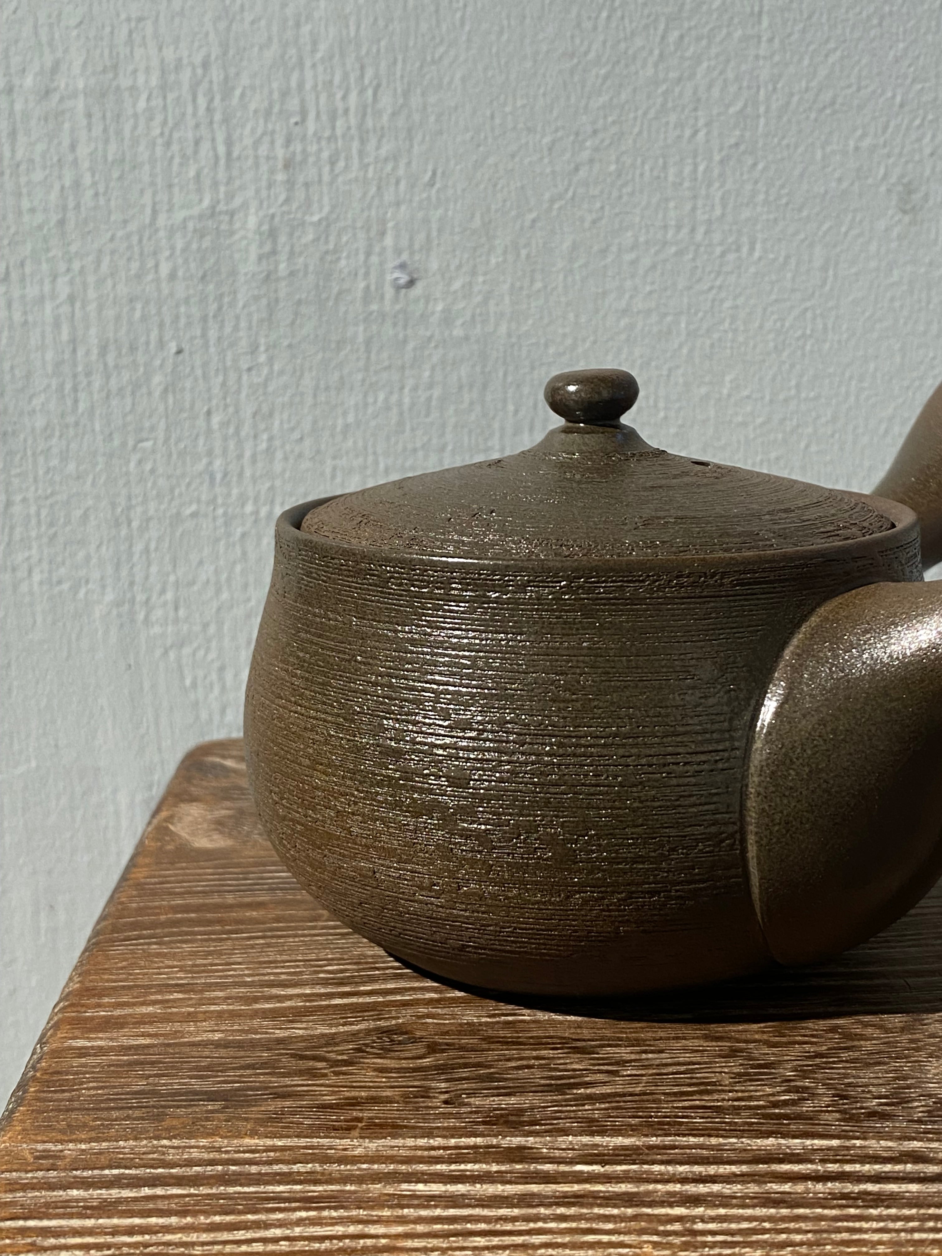 Rustic dark brown teapot with handle