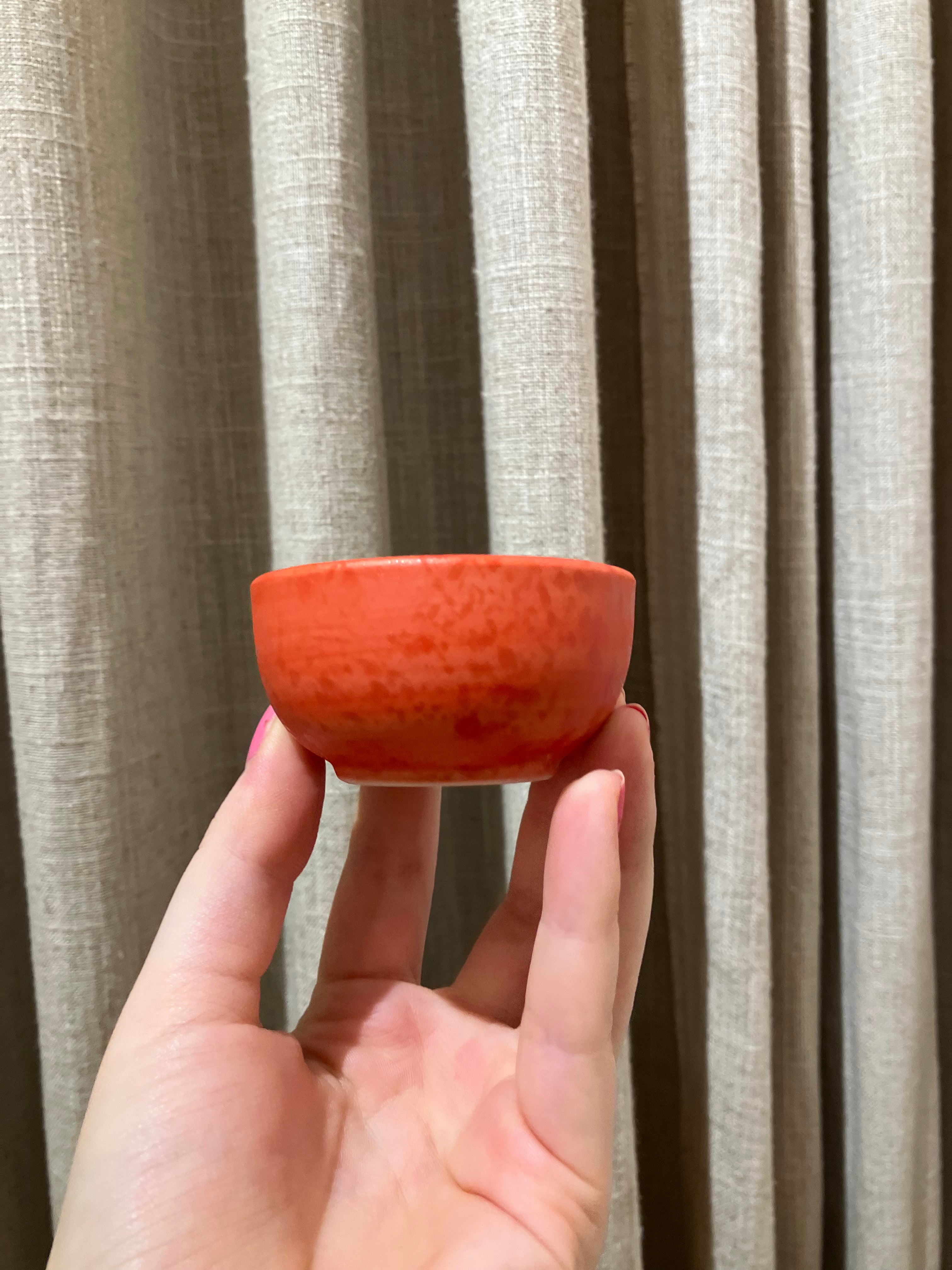 Small red bowl with shiny spots