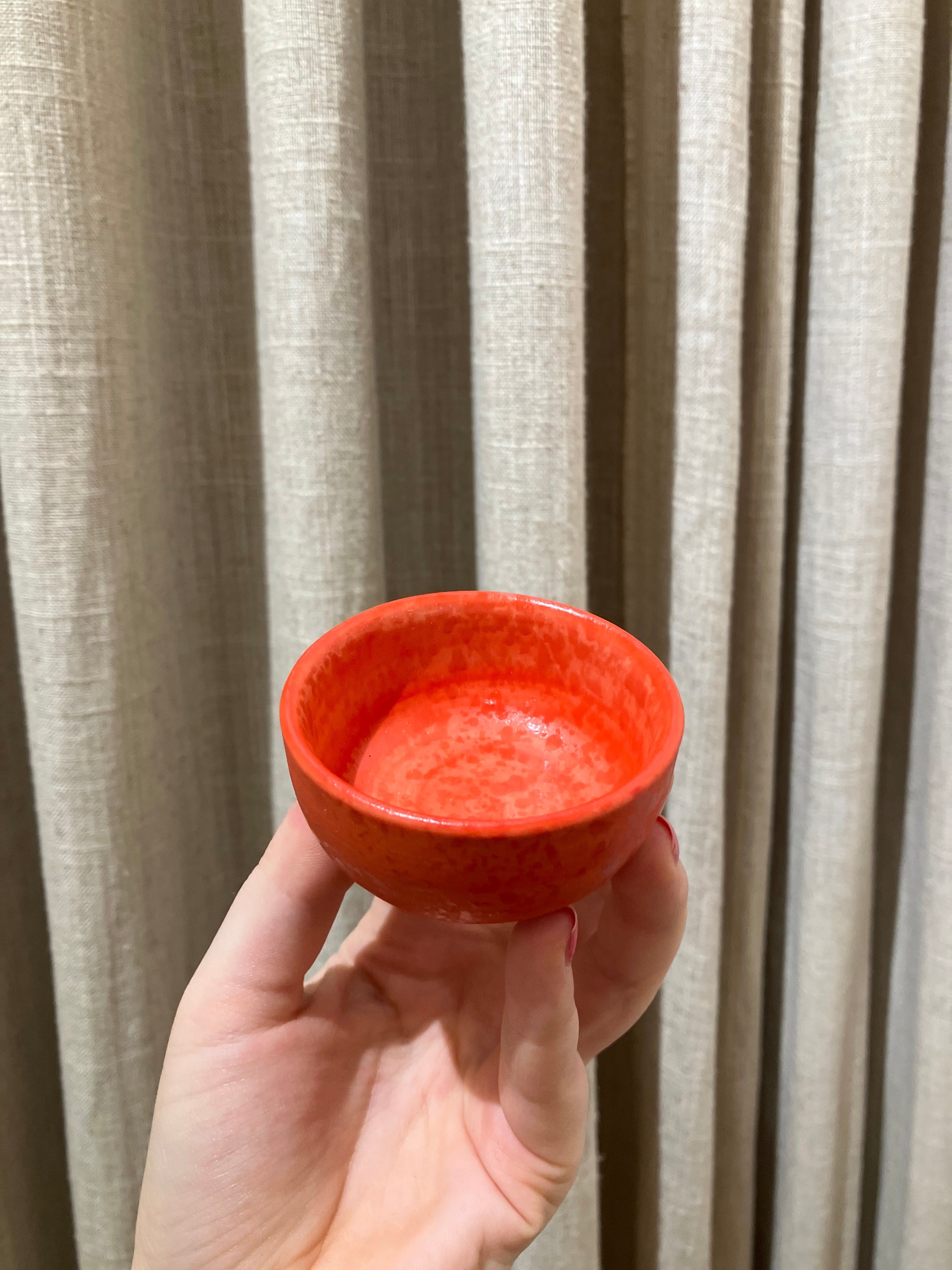 Small red bowl with shiny spots