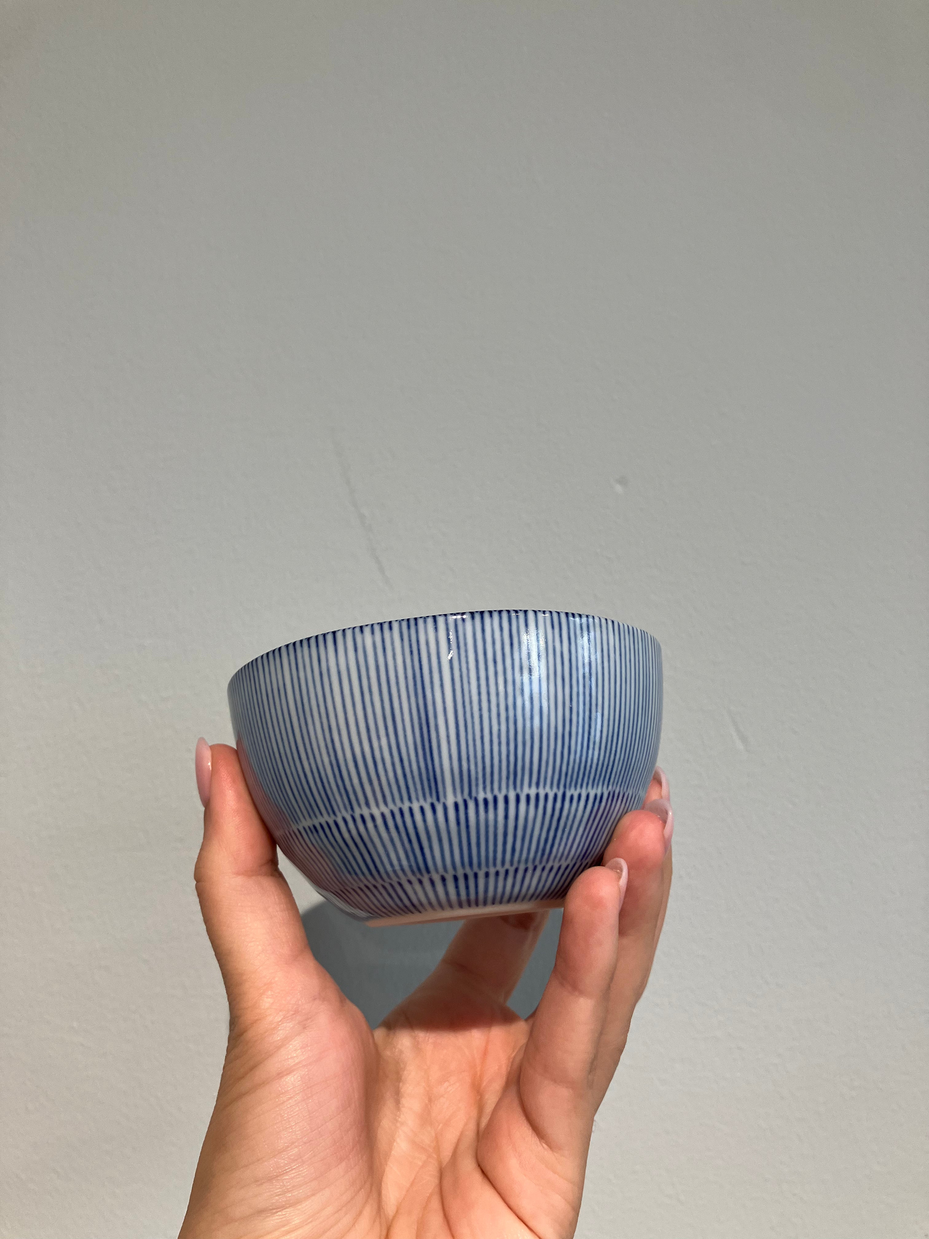 Small bowl with white glaze and blue thin stripes