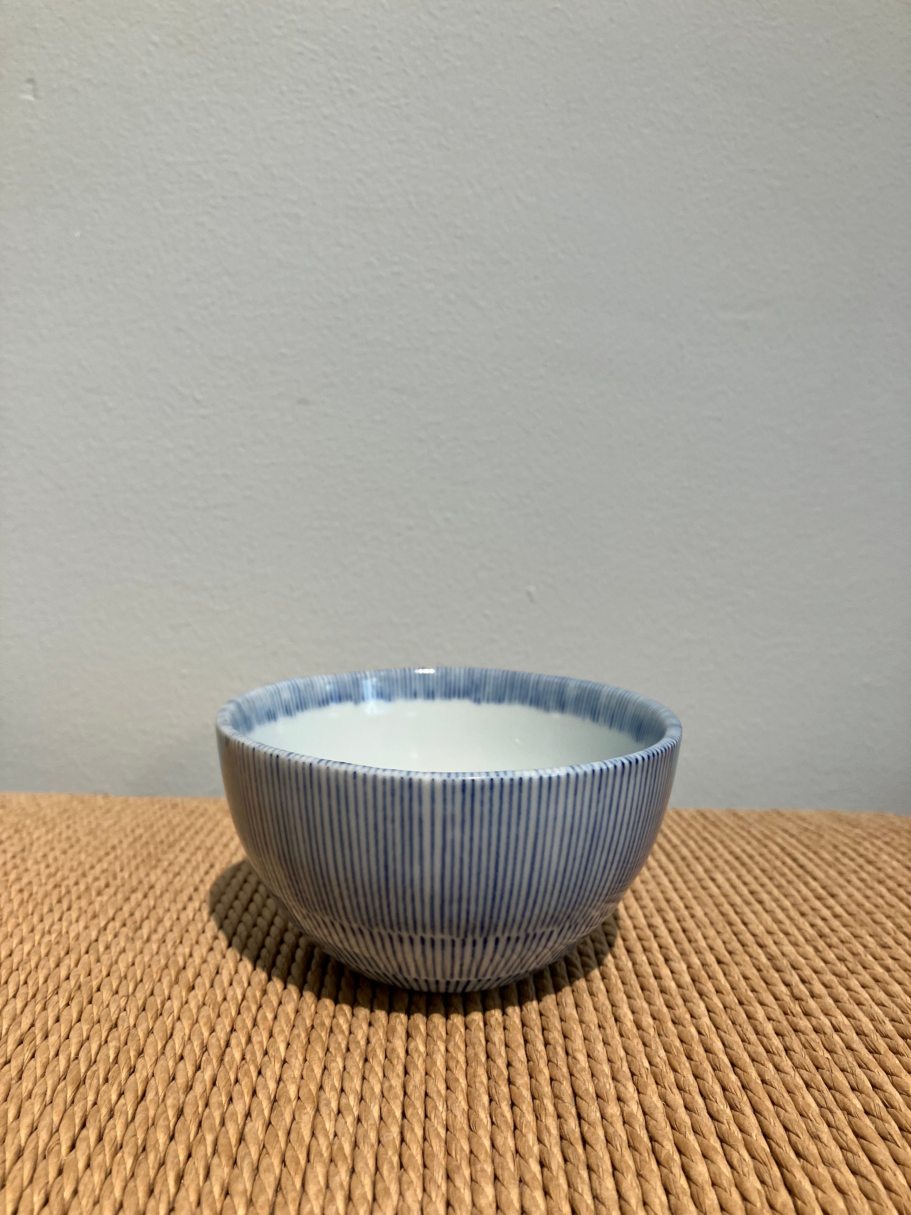 Small bowl with white glaze and blue thin stripes