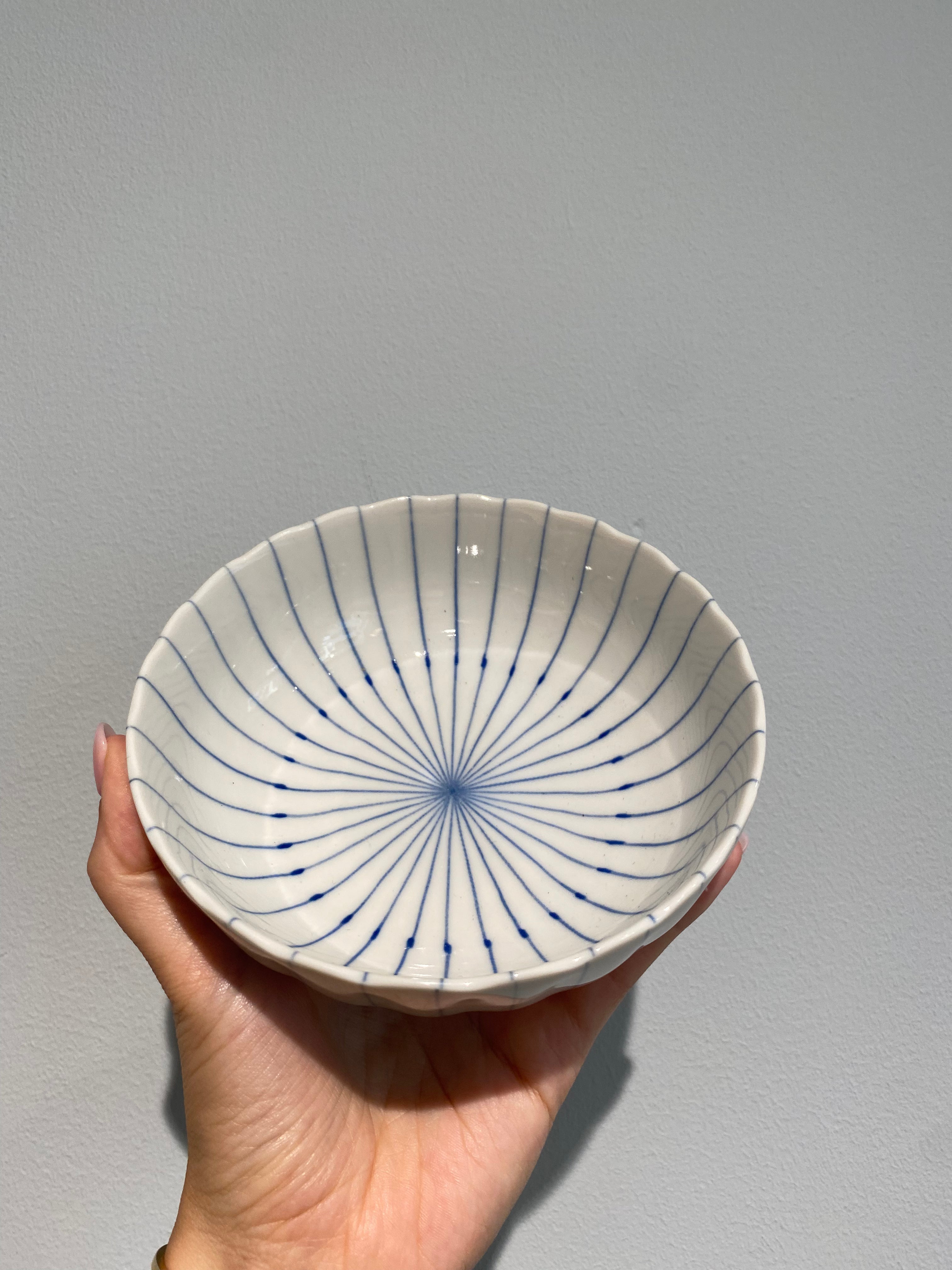 Bowls with blue thin stripes and wavy edge
