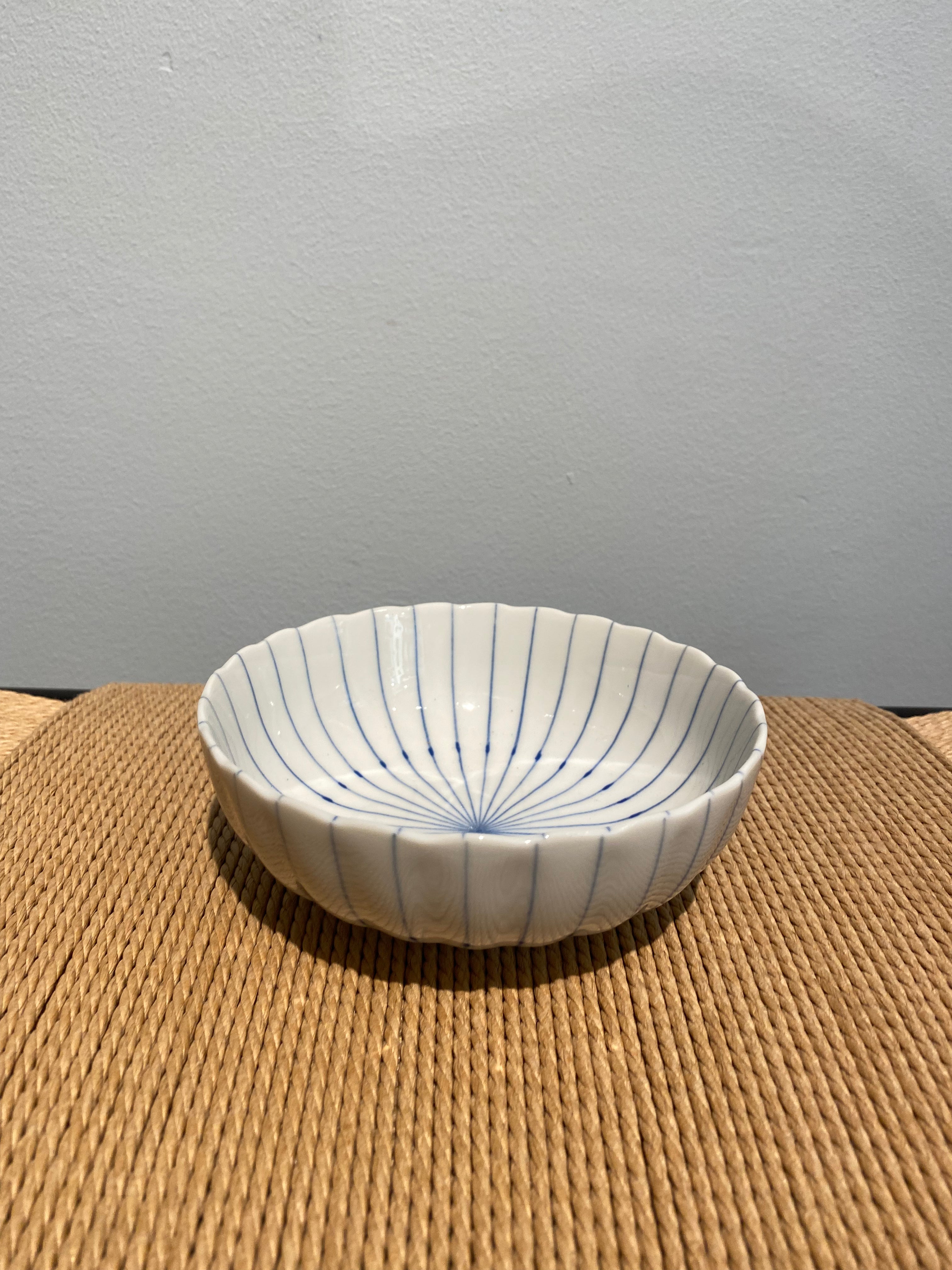 Bowls with blue thin stripes and wavy edge
