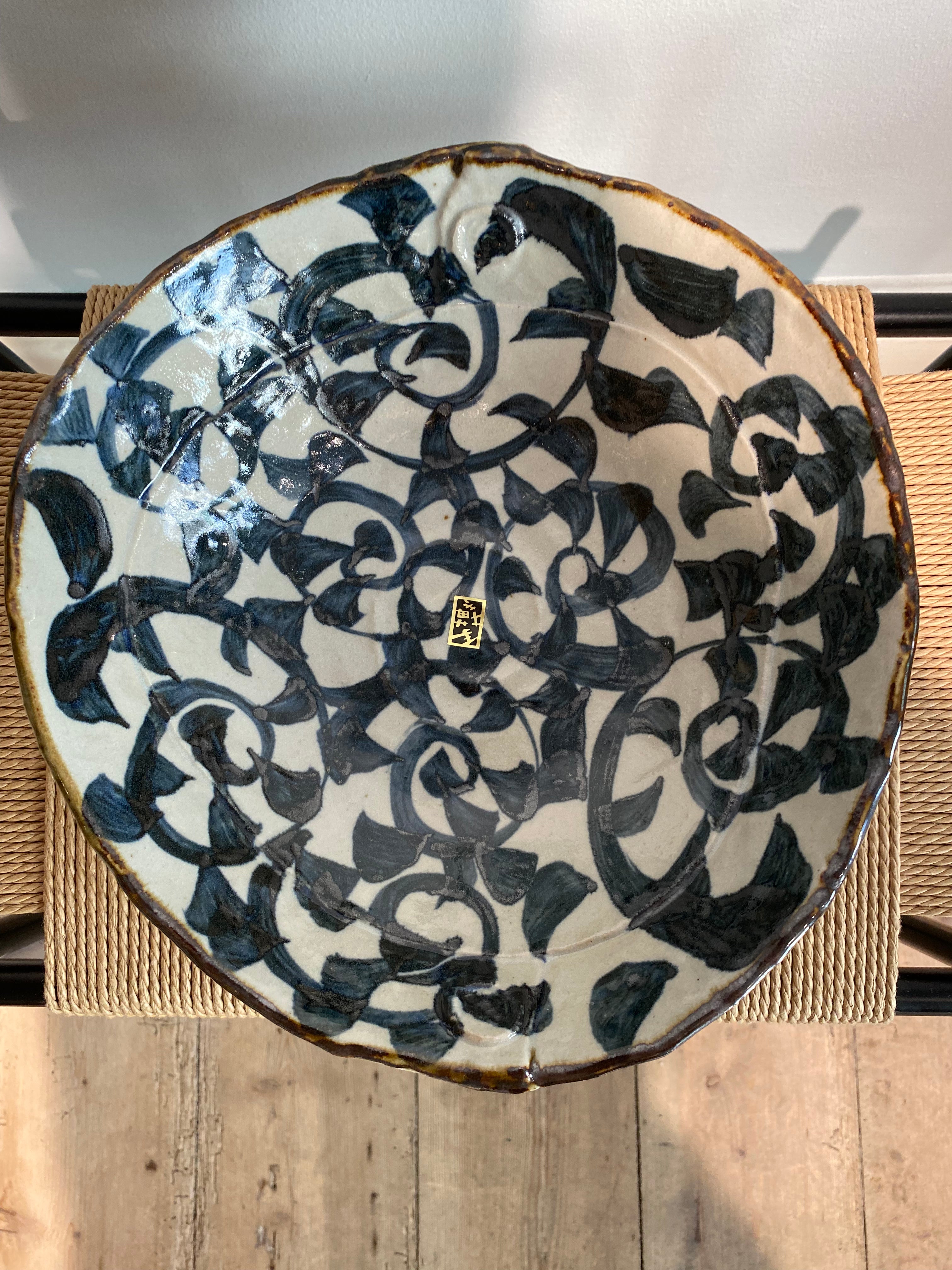 Large bowl with white glaze and dark blue pattern and brown rim