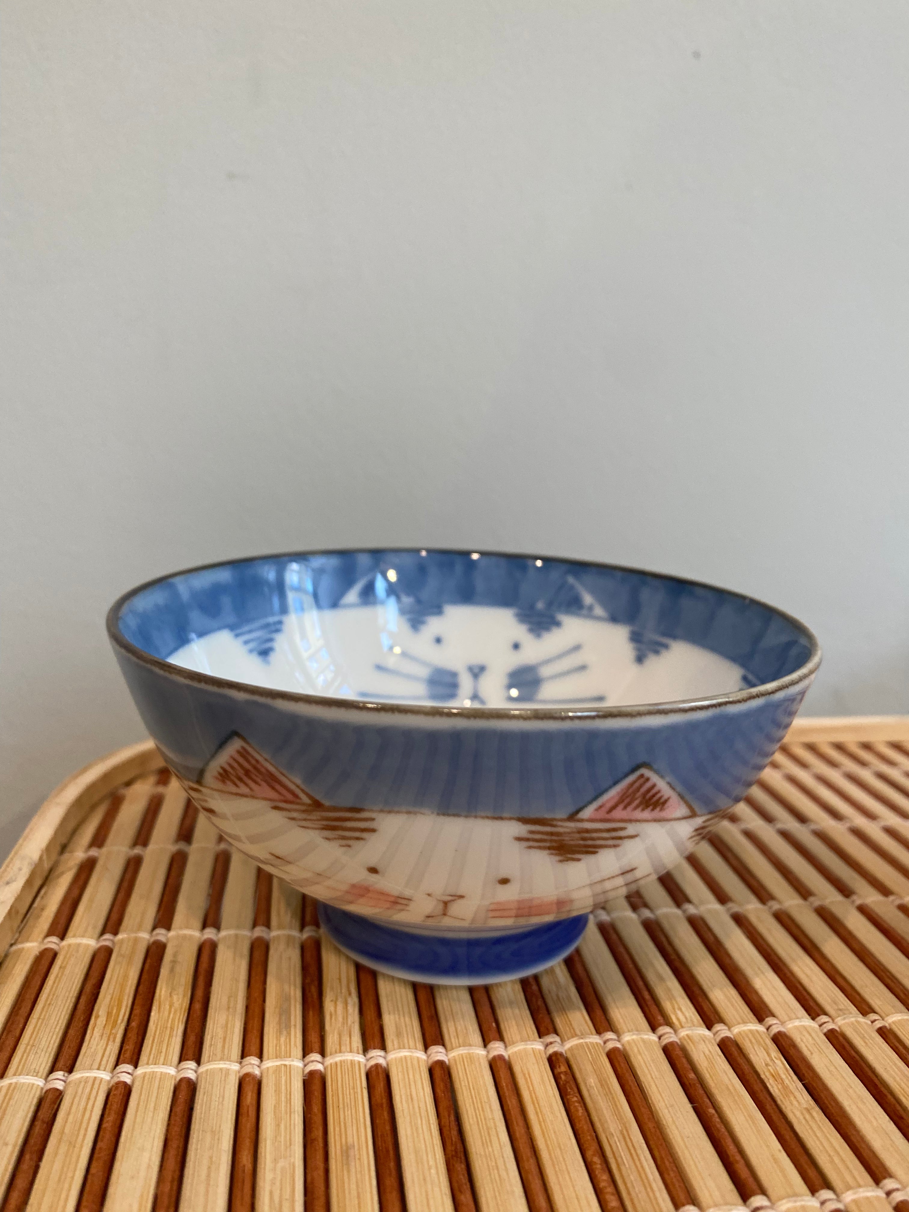 Cat bowls with a cat motif on the outside and inside