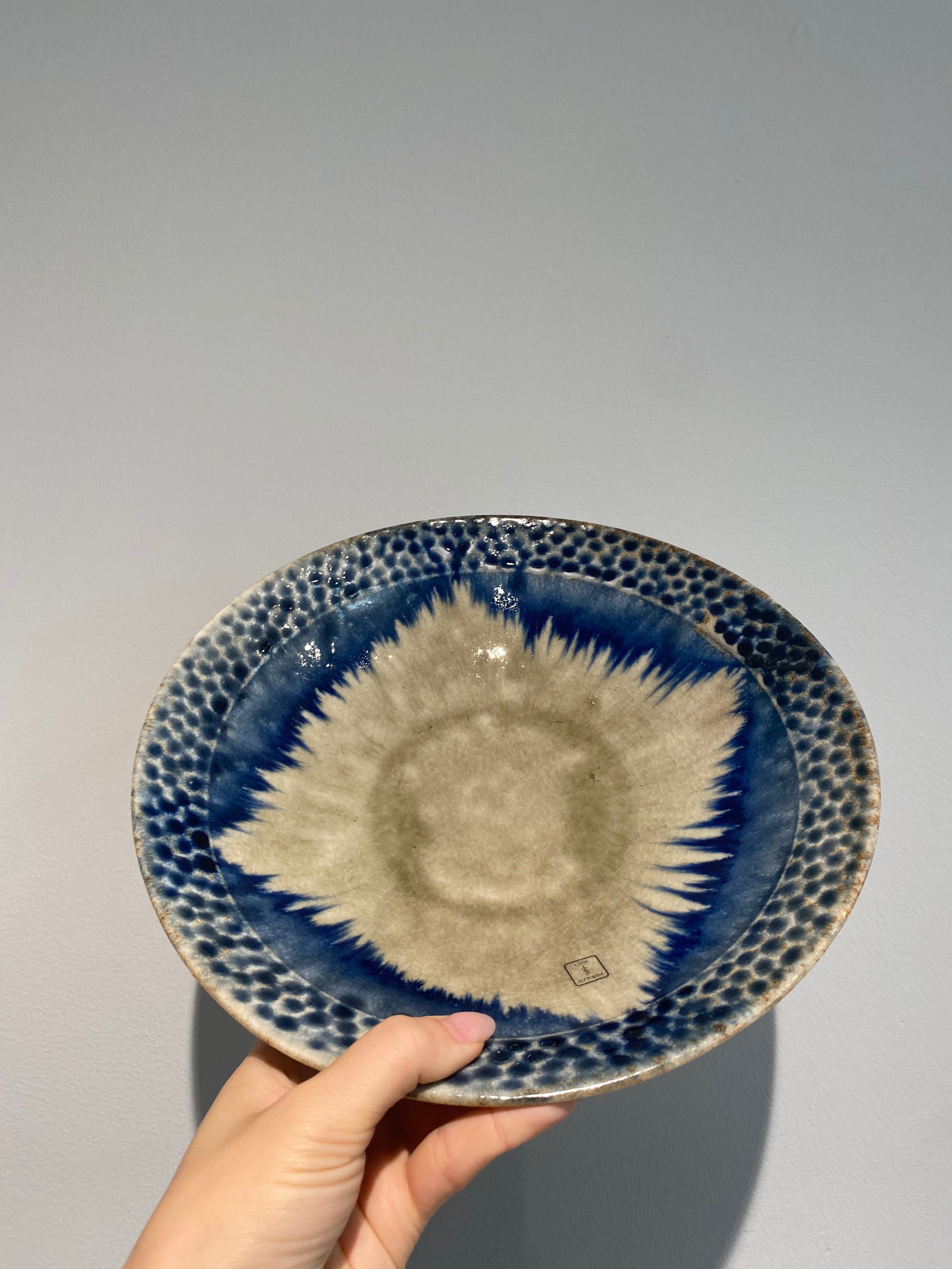 Large dish with greyish glaze and blue dots and details