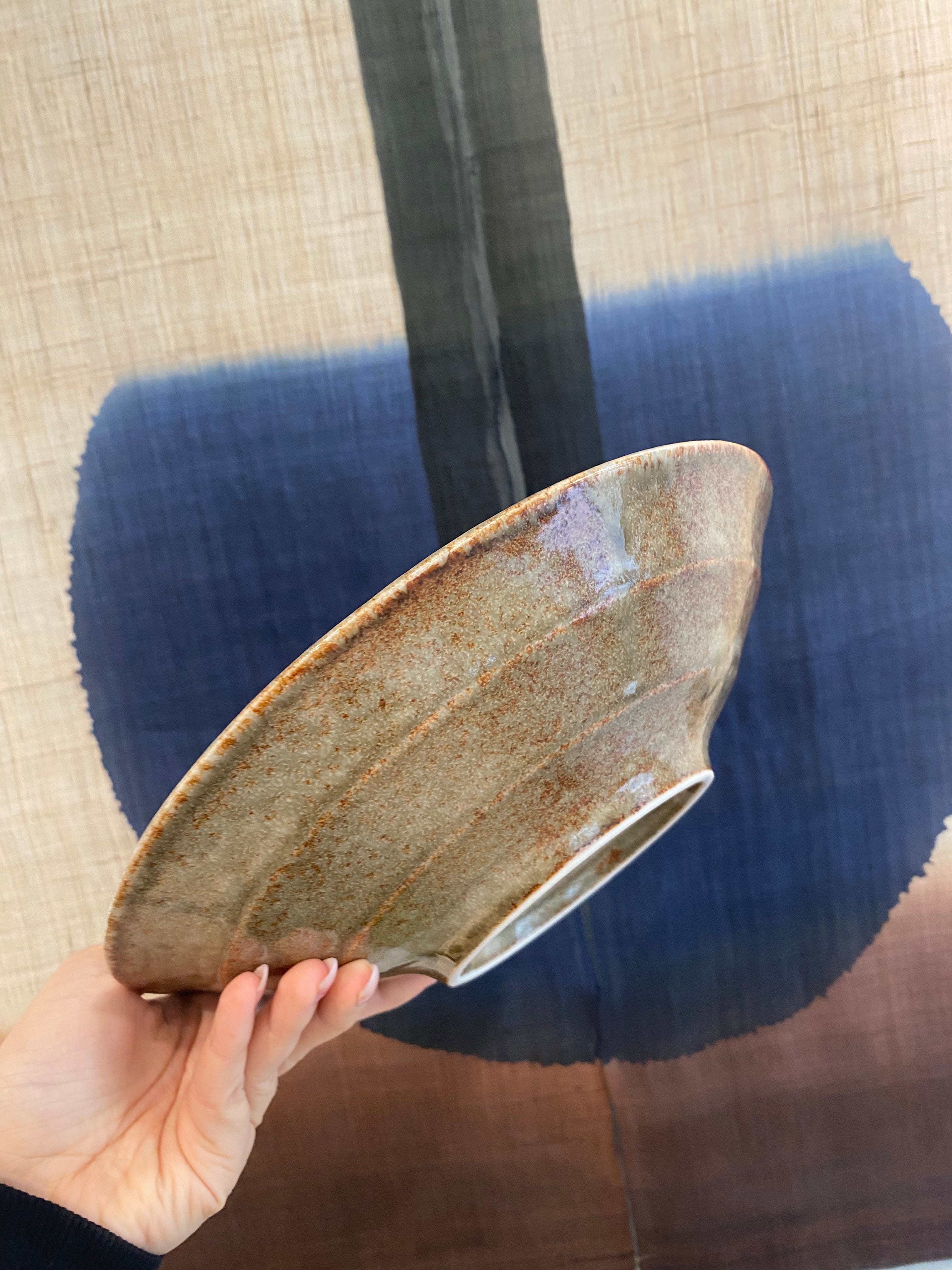 Large dish with greyish glaze and blue dots and details