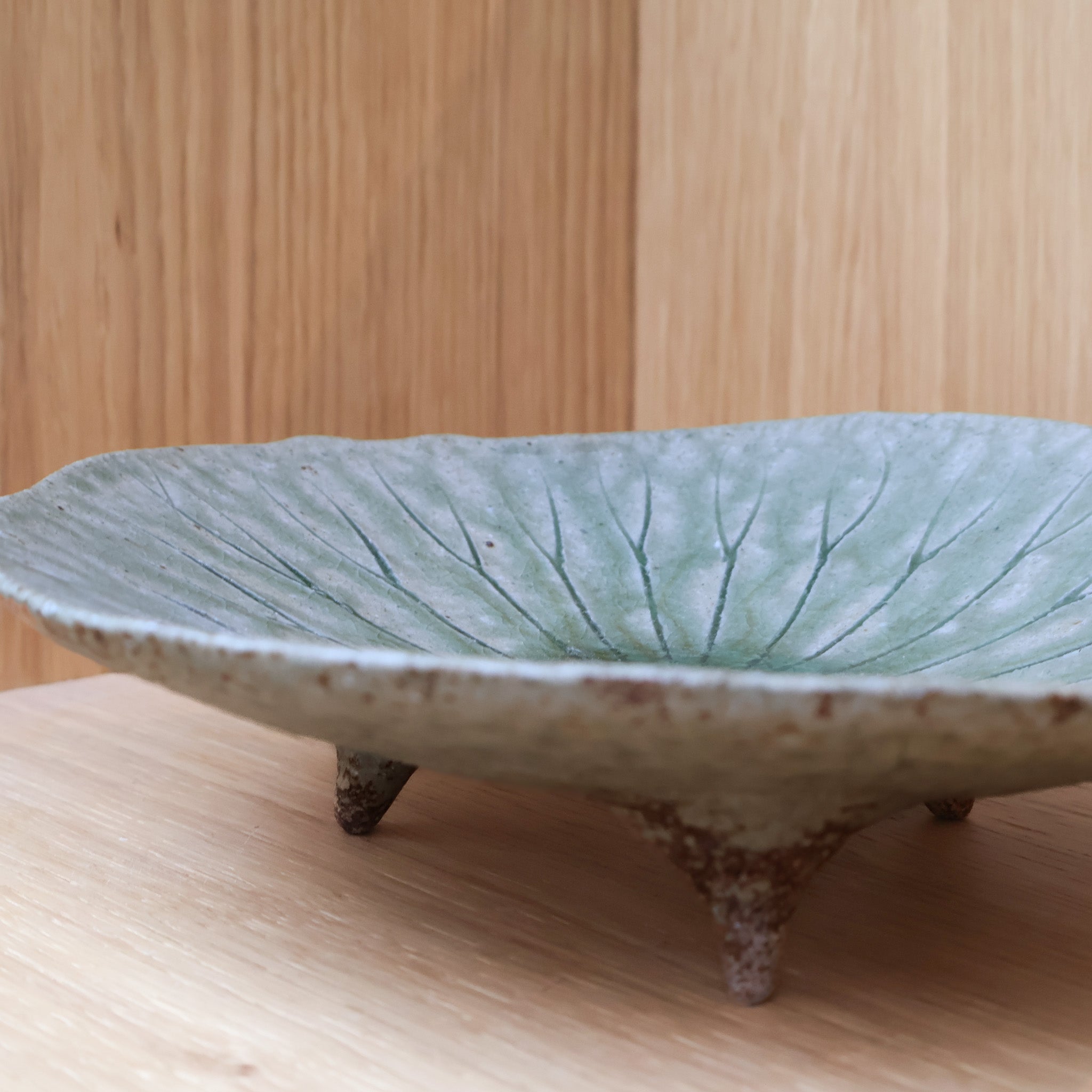 Small round dish with green leaf pattern