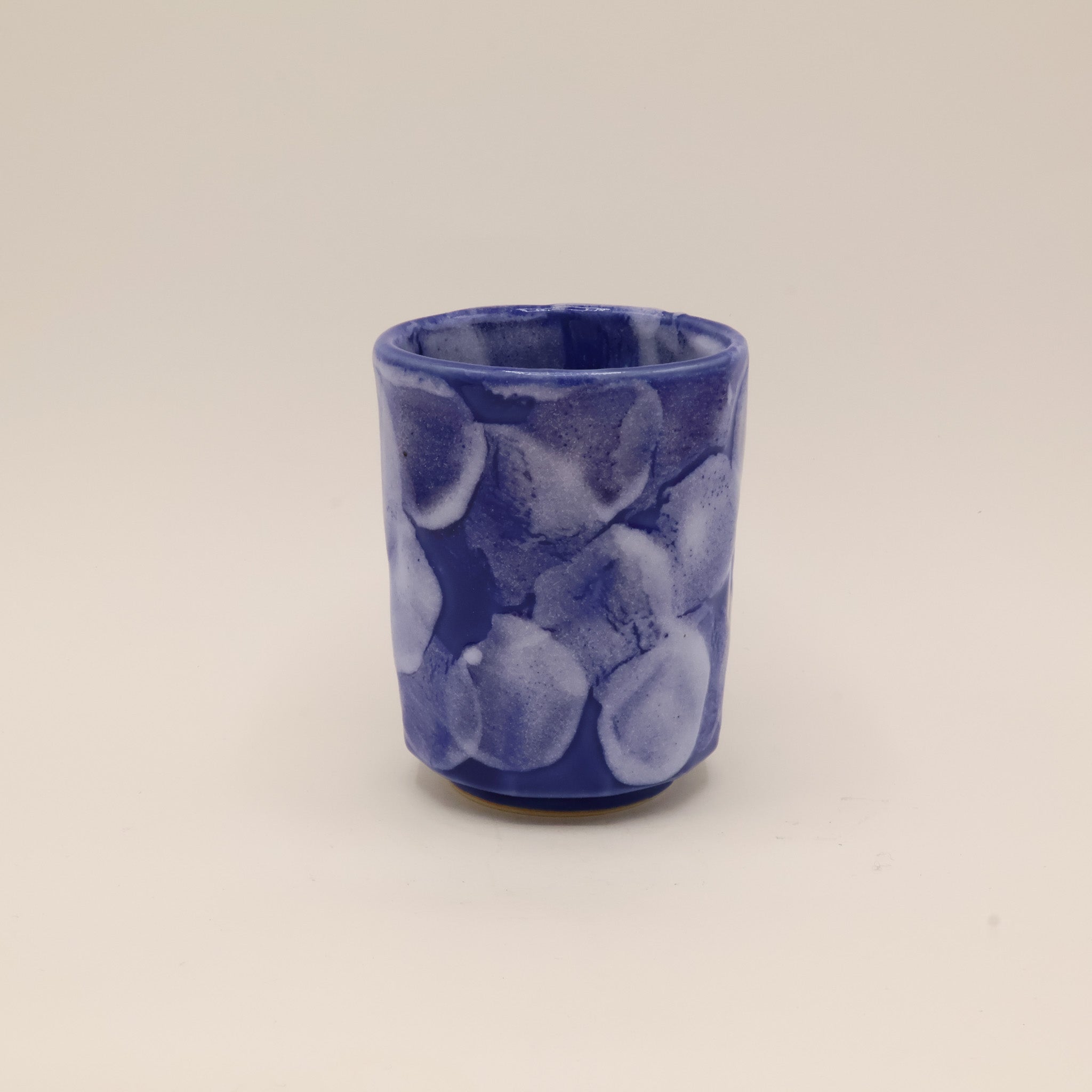Ceramic cup with blue glaze and white details