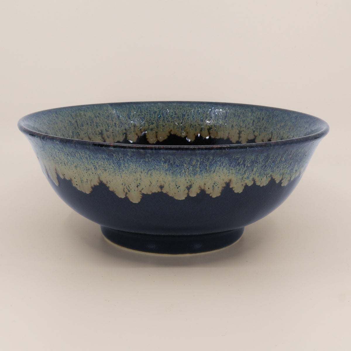 Black ramen bowl with running green and blue glaze