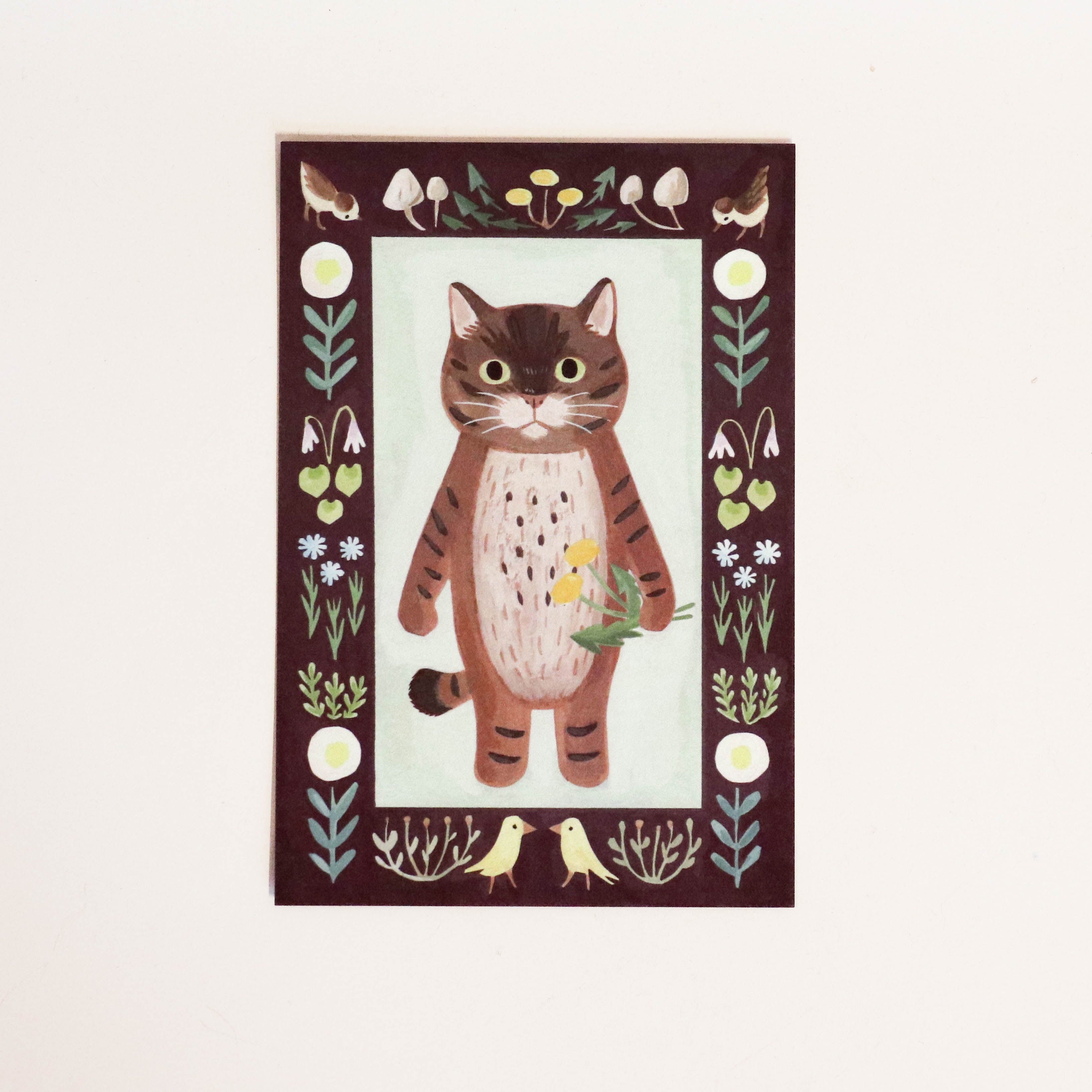Japanese card with a cat holding a pair of dandelions