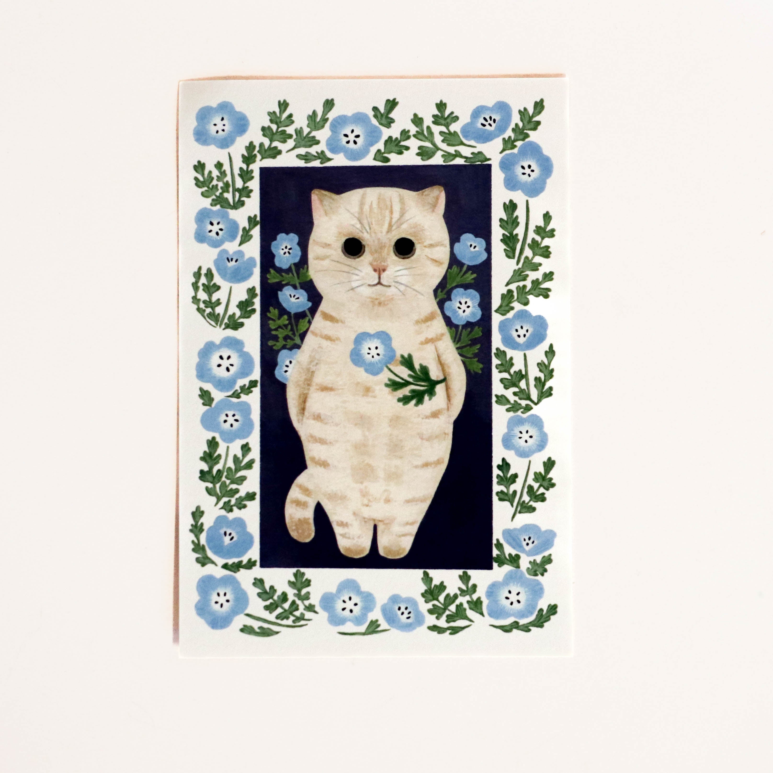 Japanese card with light gray cat holding light blue flowers